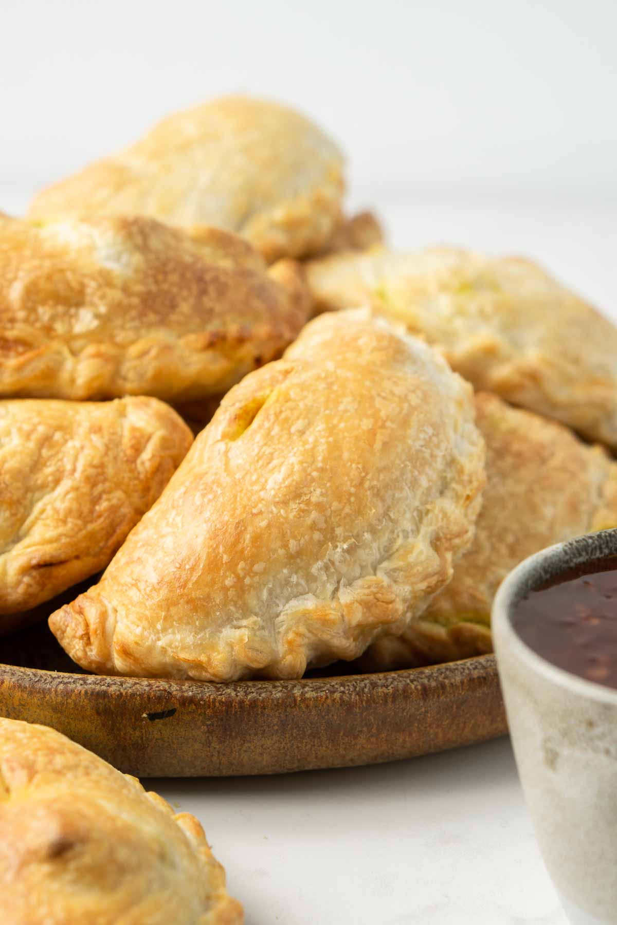 Close up of golden brown freshly baked curry puff.