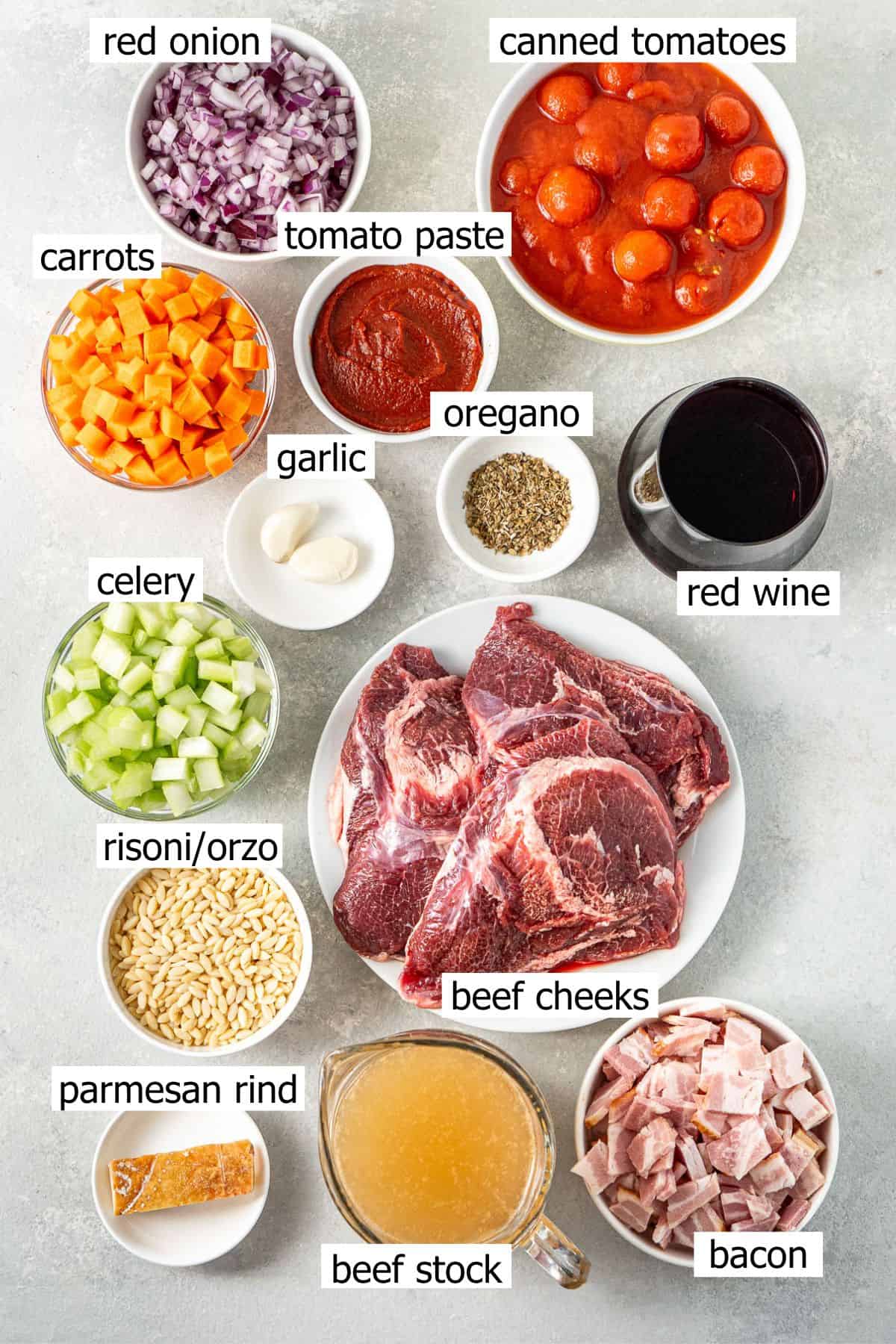 All ingredients needed to make beef minestrone soup laid out in white bowls.
