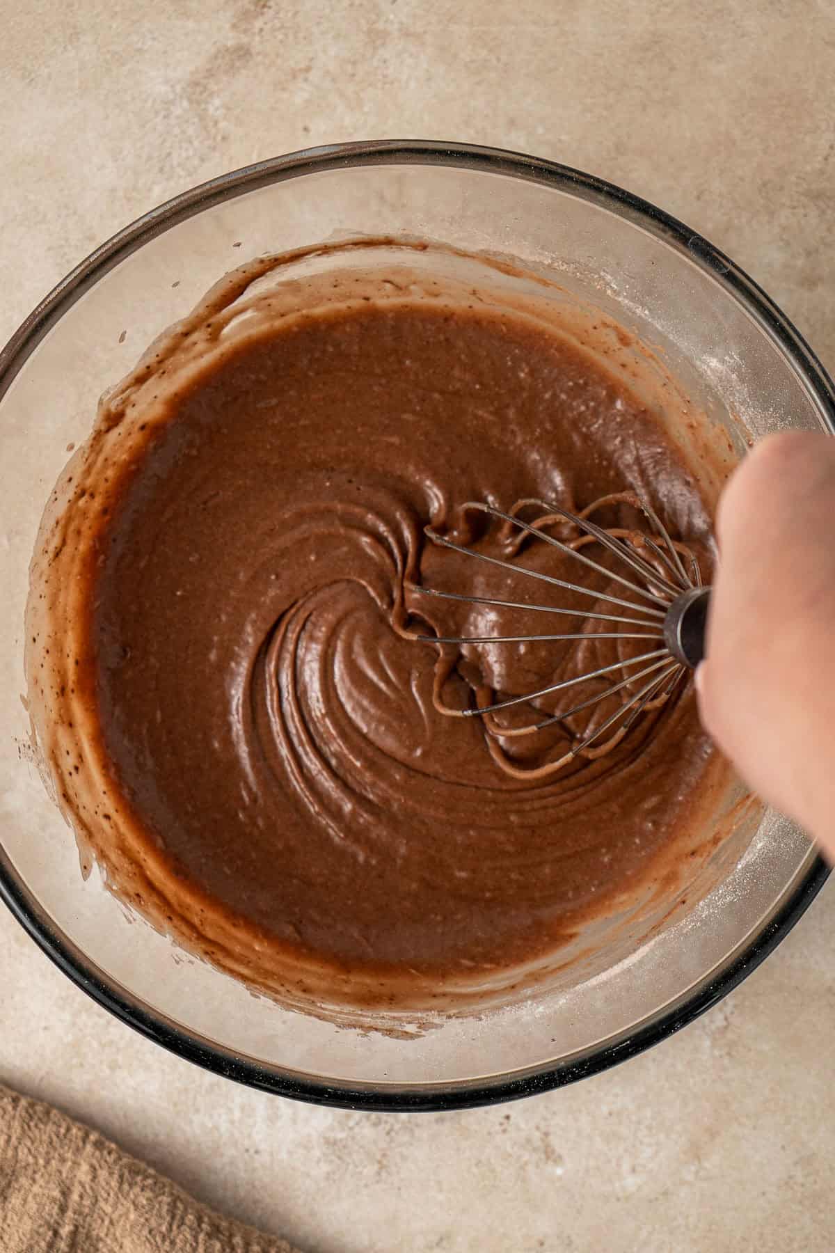 Whisking the batter together in a bowl.
