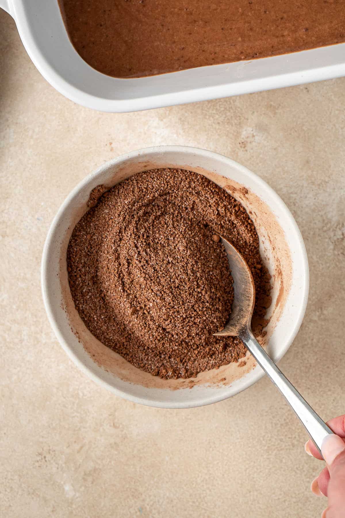 Mixing together the topping ingredients in the bowl.