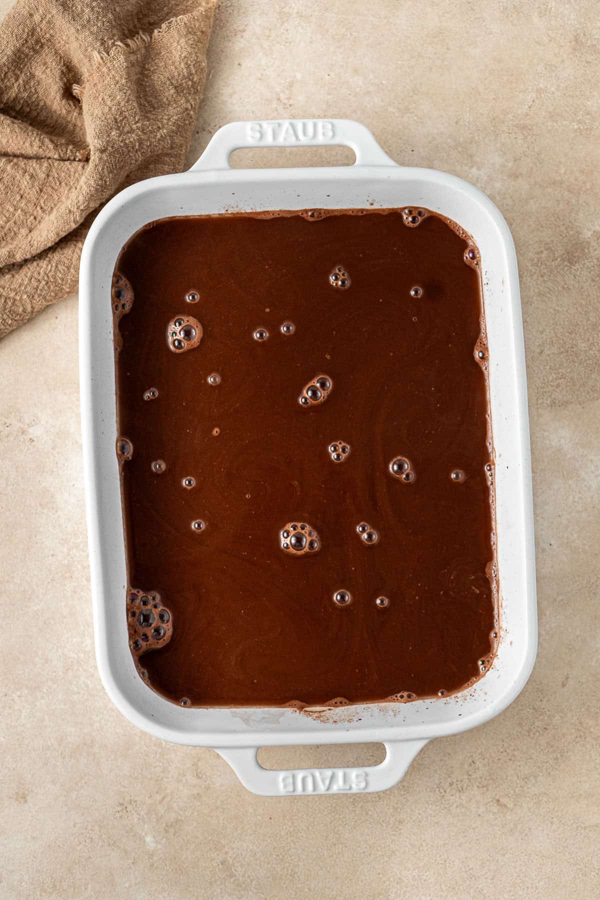 Hot water poured over the pudding in the baking dish.