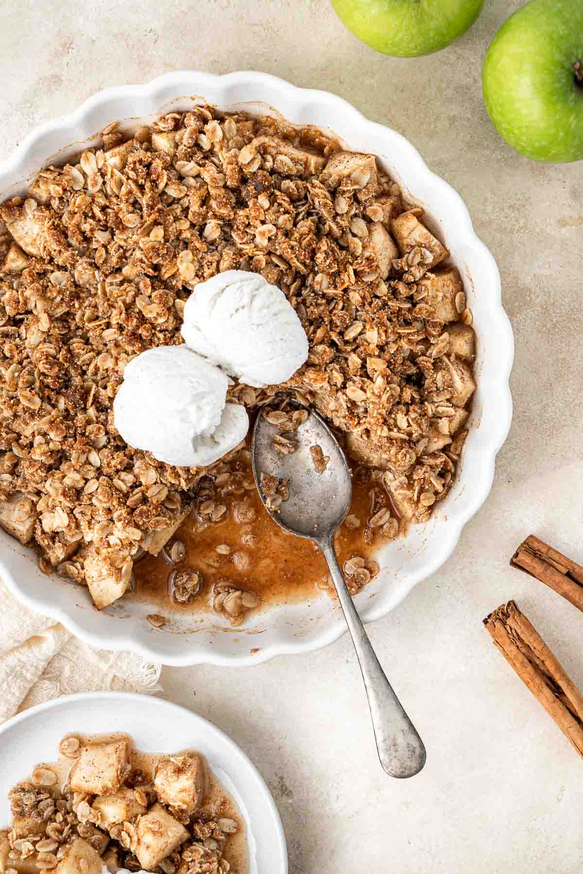 Serving dairy free apple crumble with a spoon. 