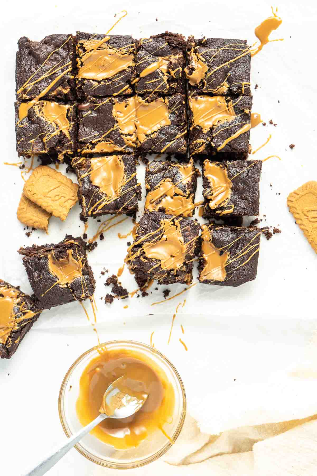 Vegan biscoff brownies with extra biscoff drizzle from above. 