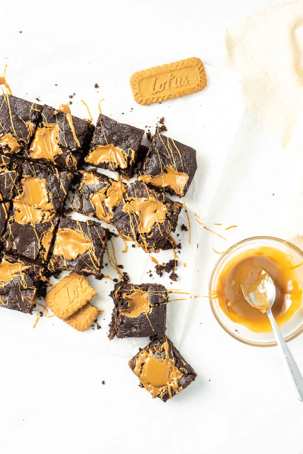 Vegan biscoff brownies sliced into squares with extra biscoff drizzled over the top.