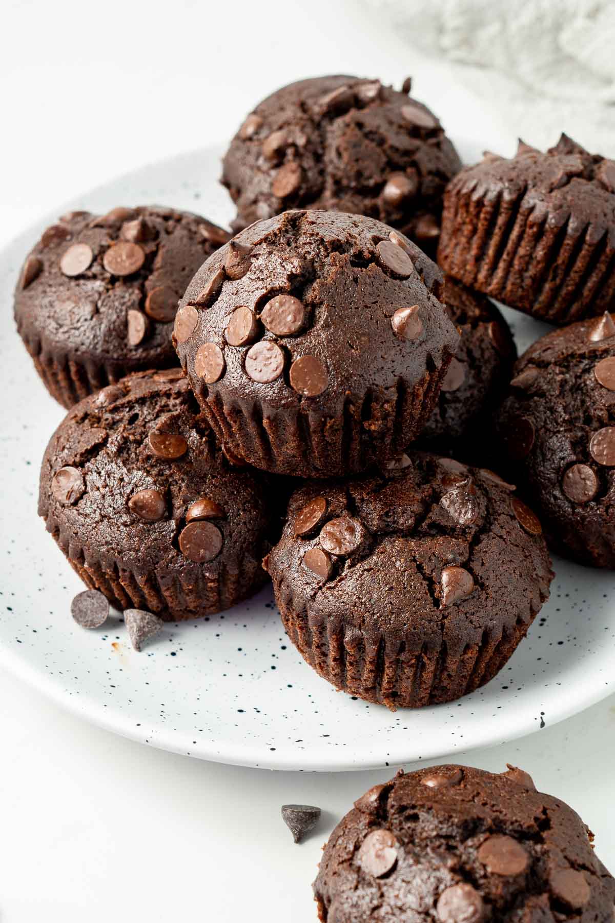 close up of chocolate muffins on a plate.