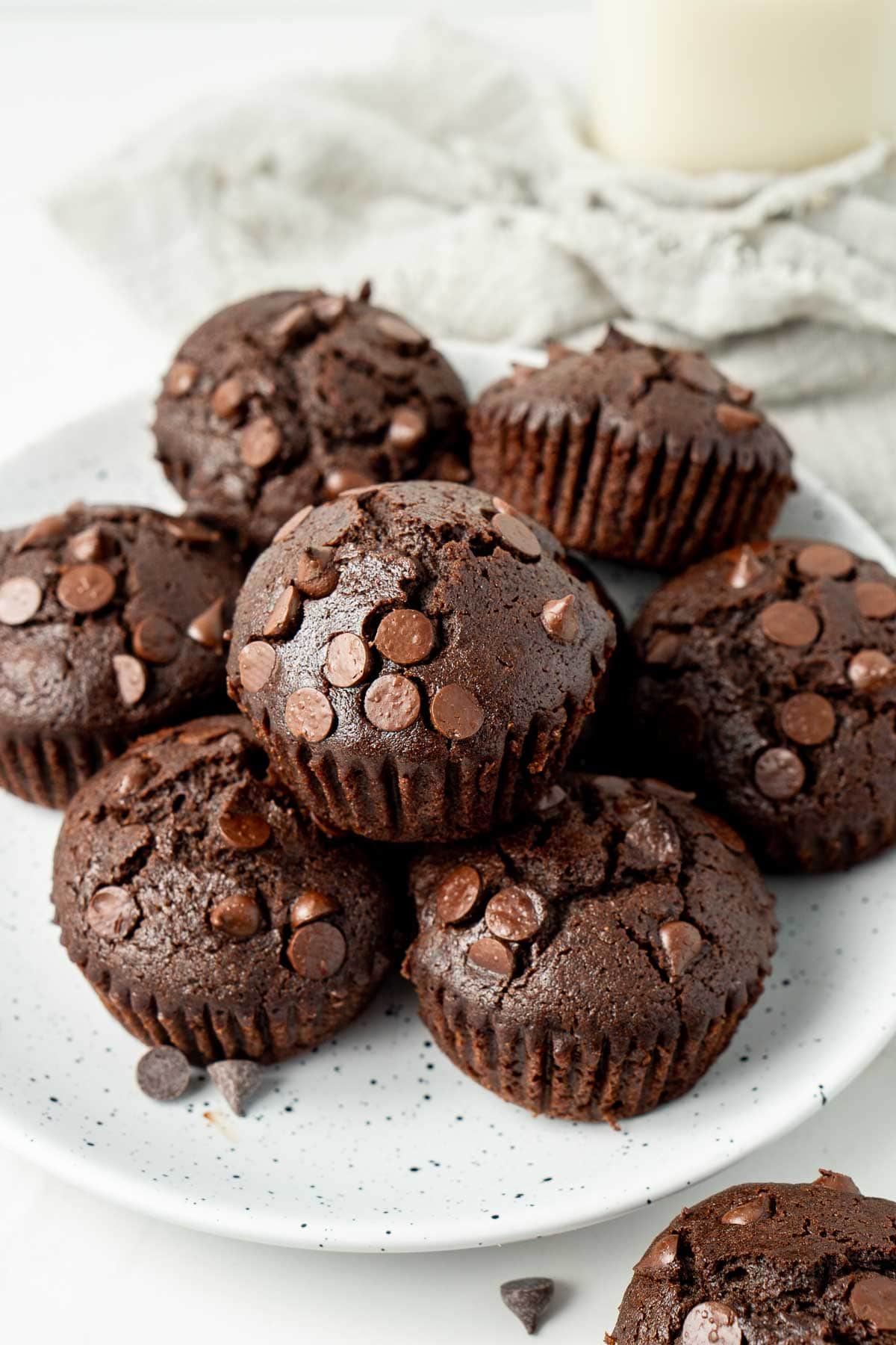 Vegan chocolate muffins on a white plate.