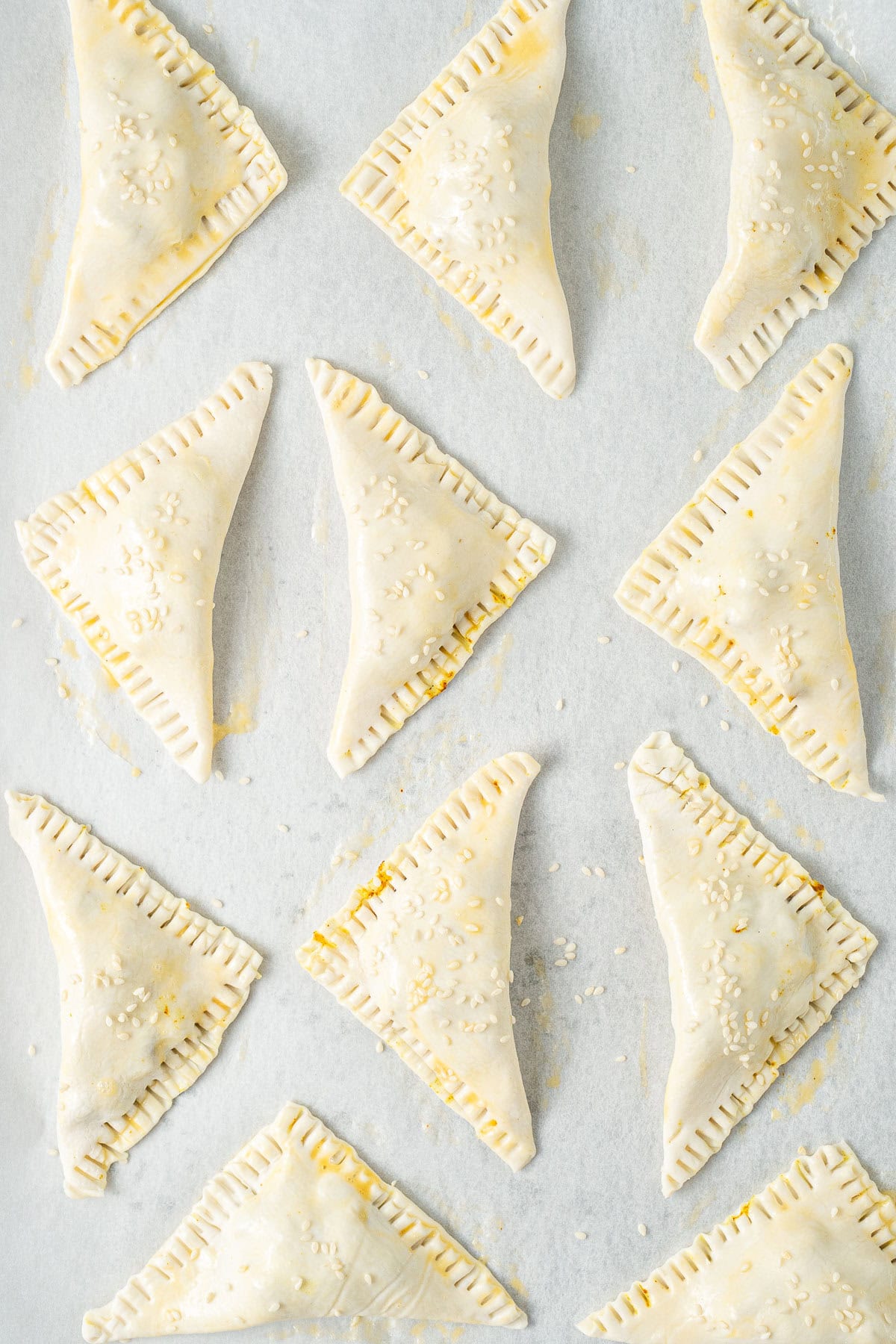 The vegetable pastries on a baking tray.