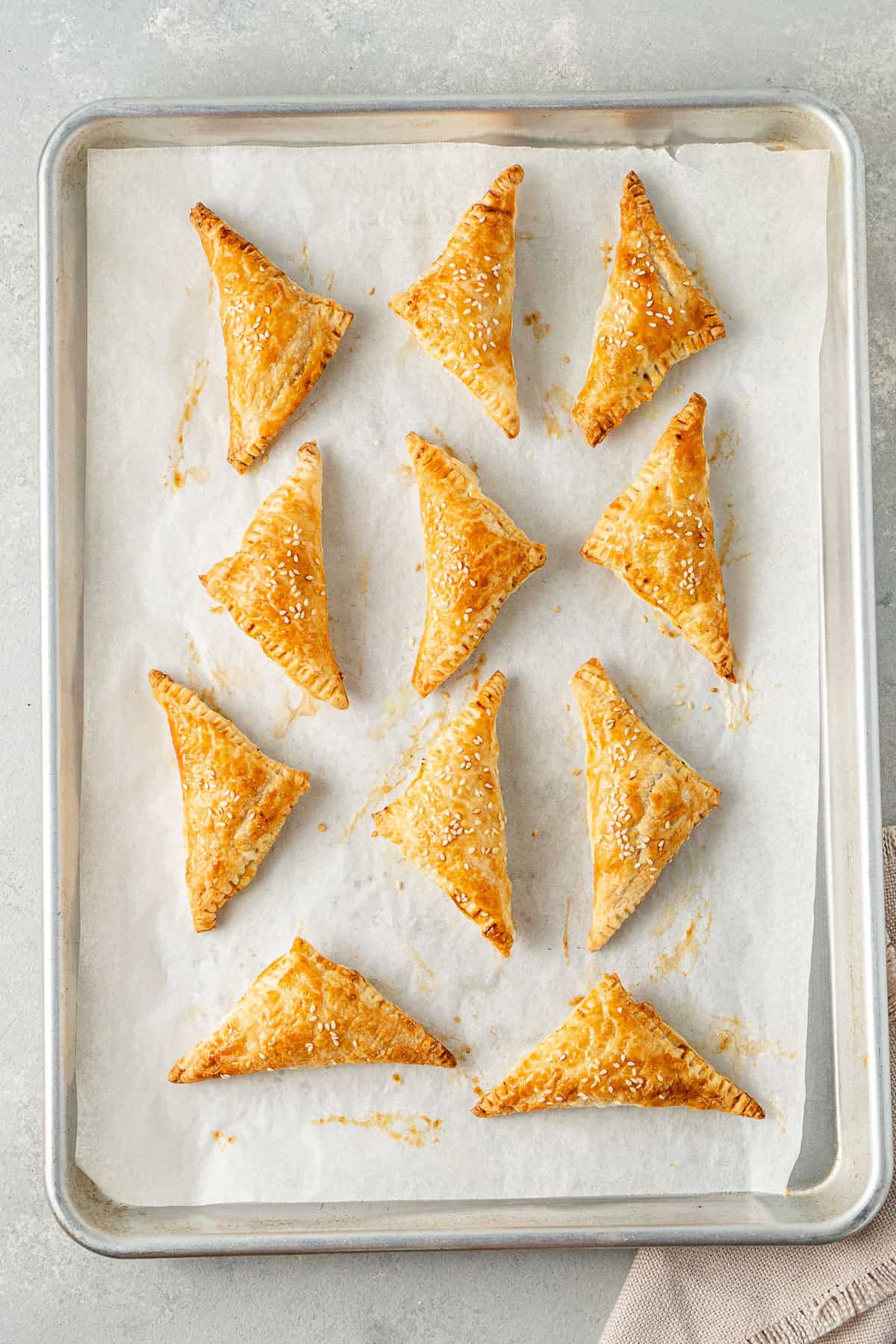 The cooked vegetable curry puff on a baking tray.