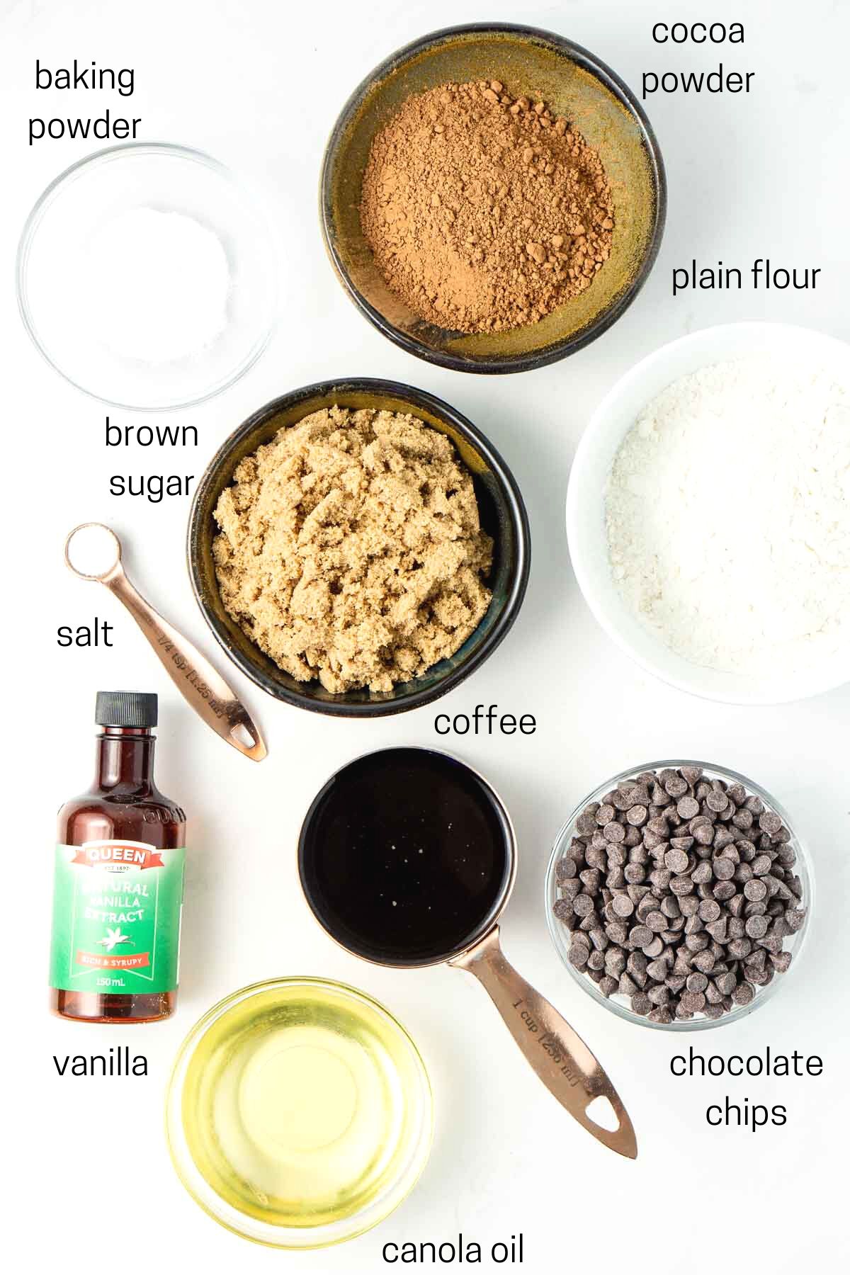 All ingredients needed to make vegan chocolate muffins laid out in small bowls.
