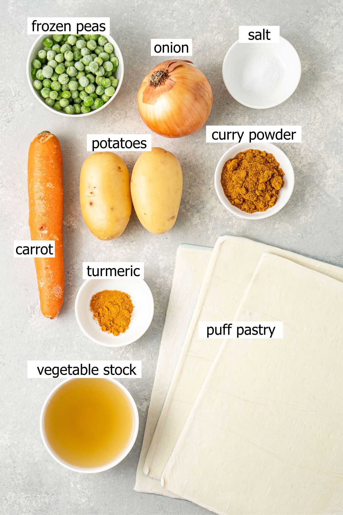All ingredients needed to make vegetarian curry puff laid out in small bowls.