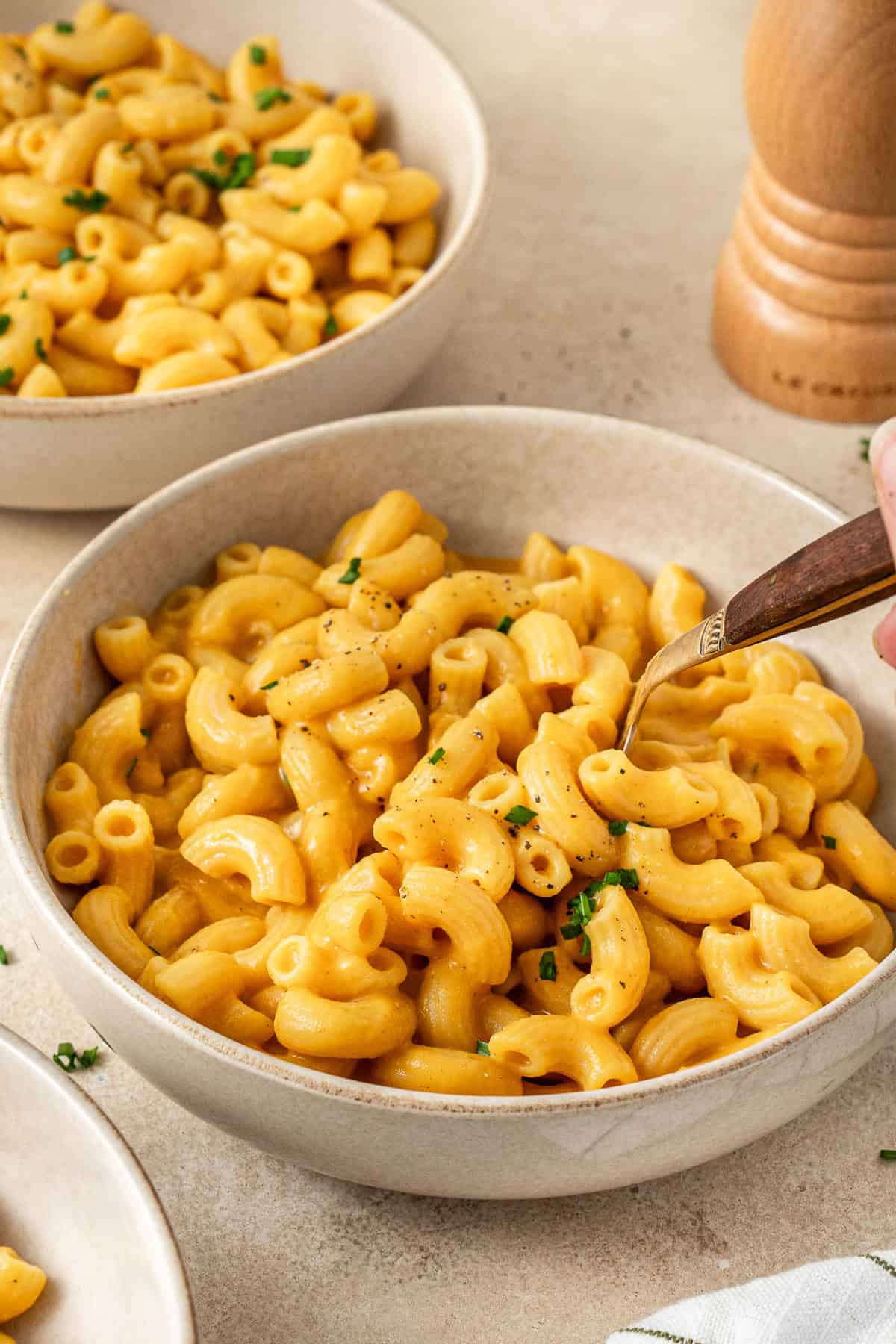 A fork taking a bite of sweet potato pasta. 