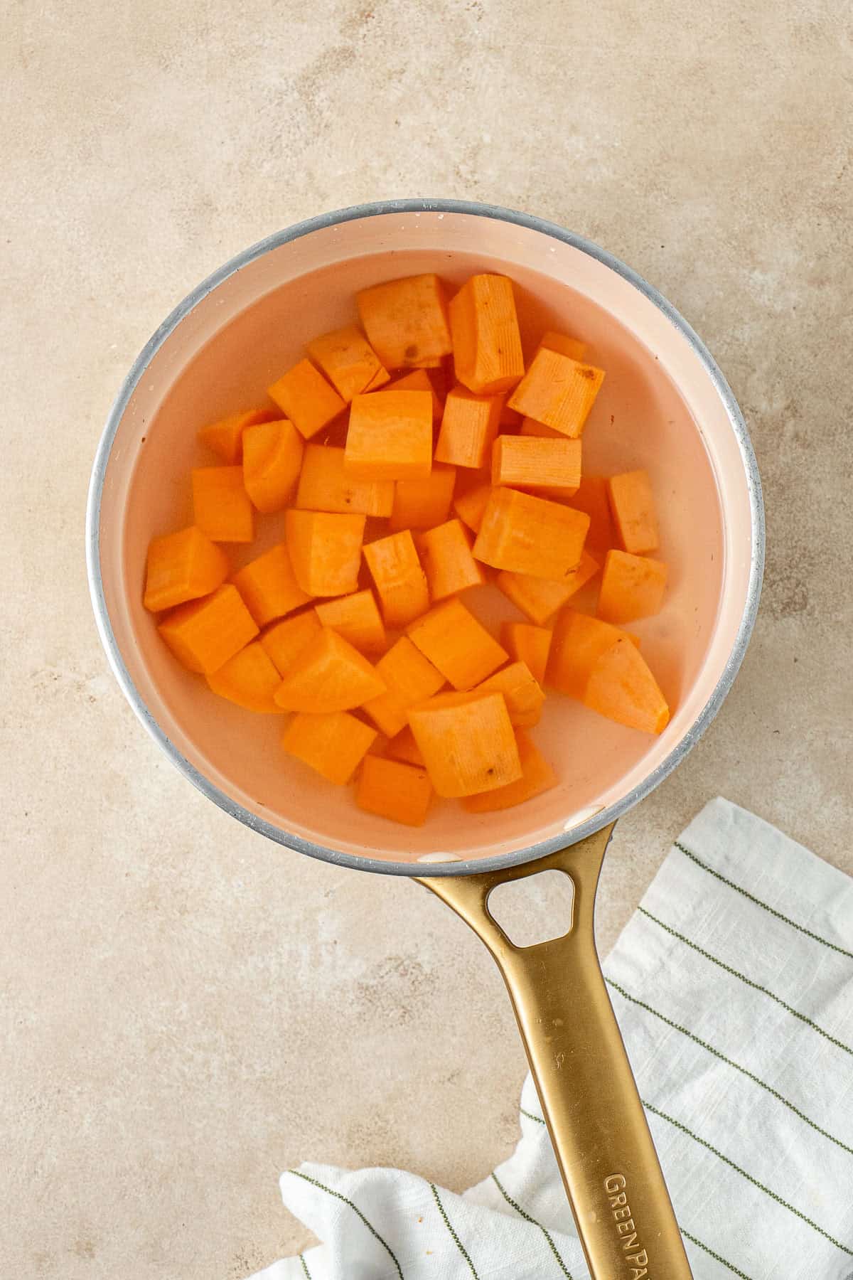 Sweet potato chopped in a pot.