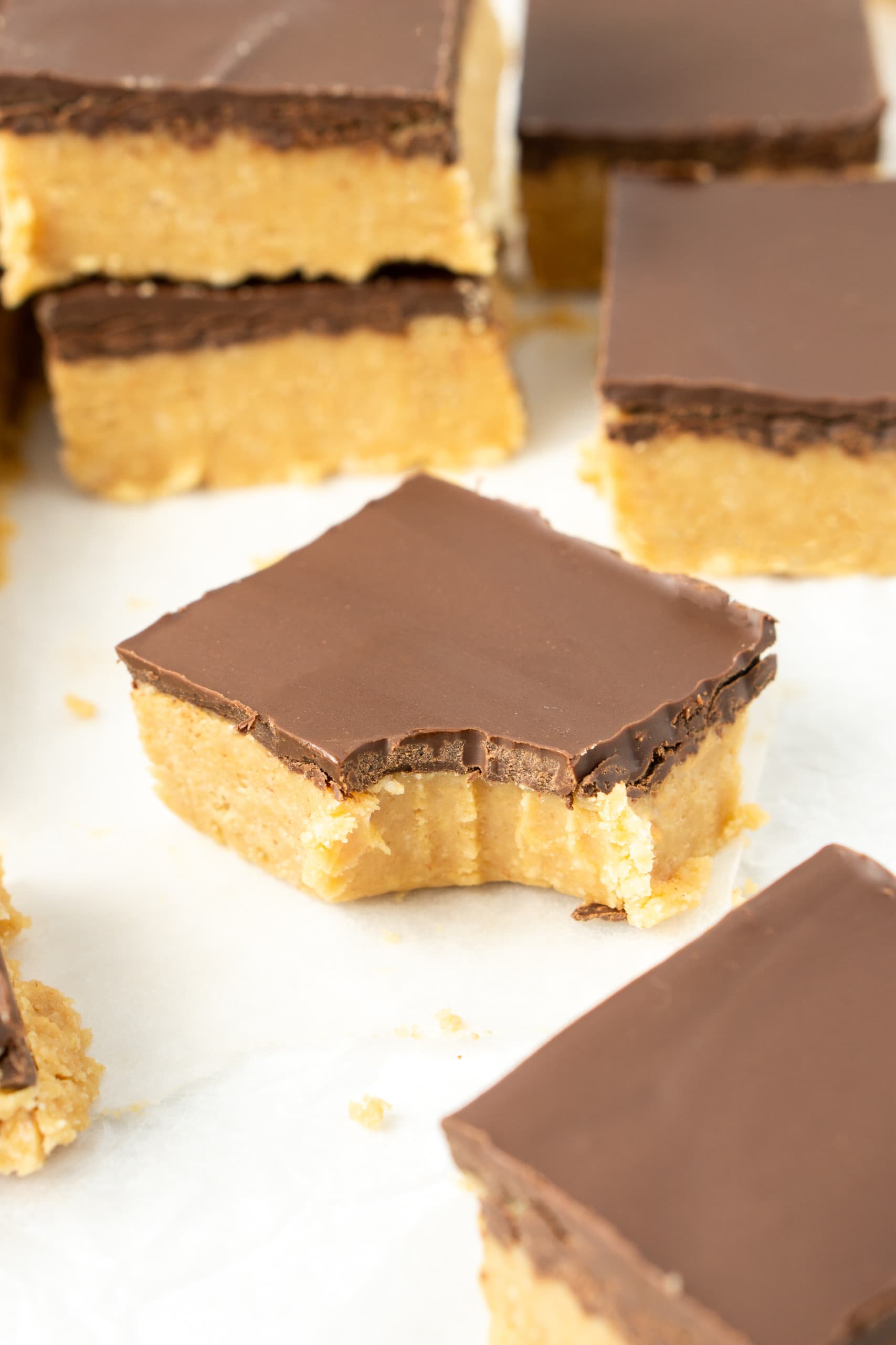 Close up of a peanut butter bar with a bite taken.