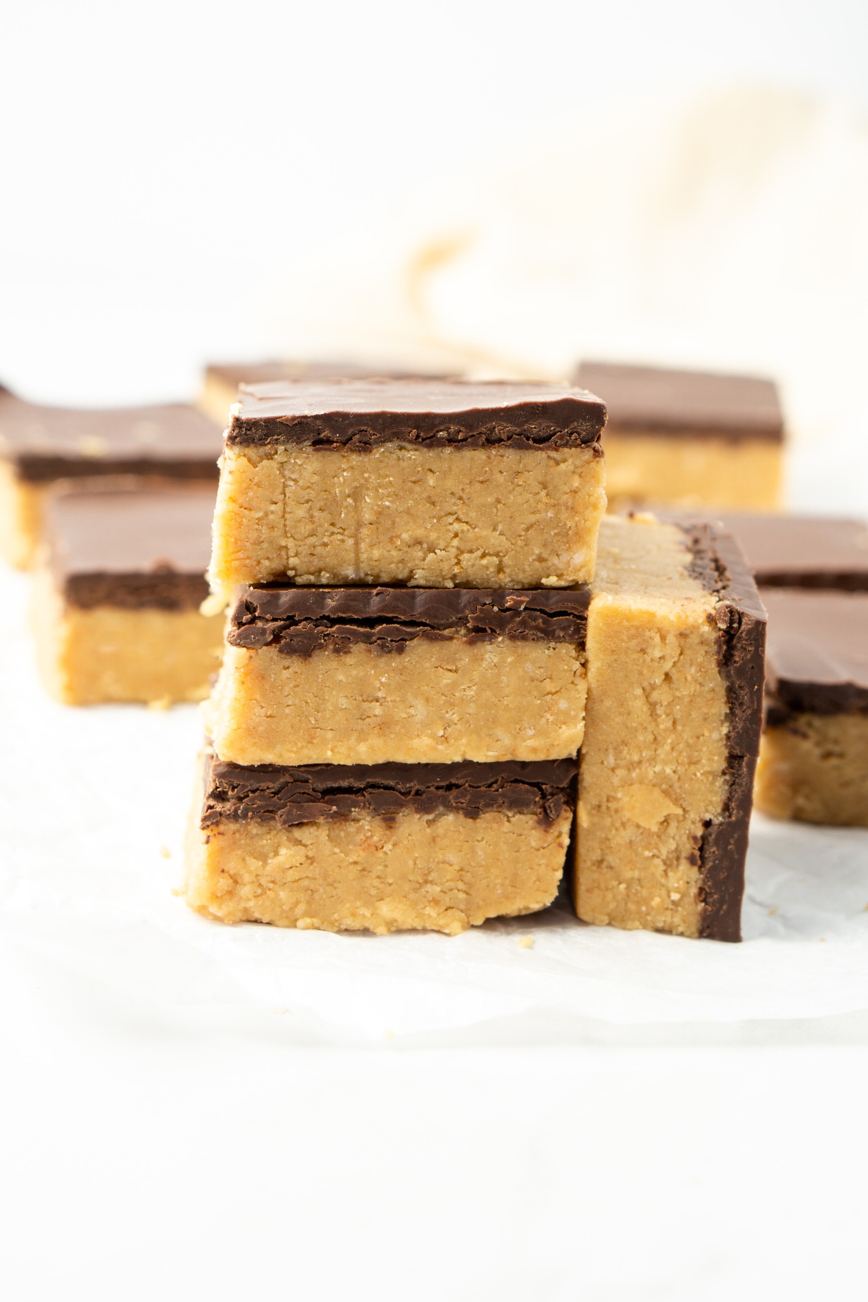 Vegan peanut butter bars stacked on top of each other.