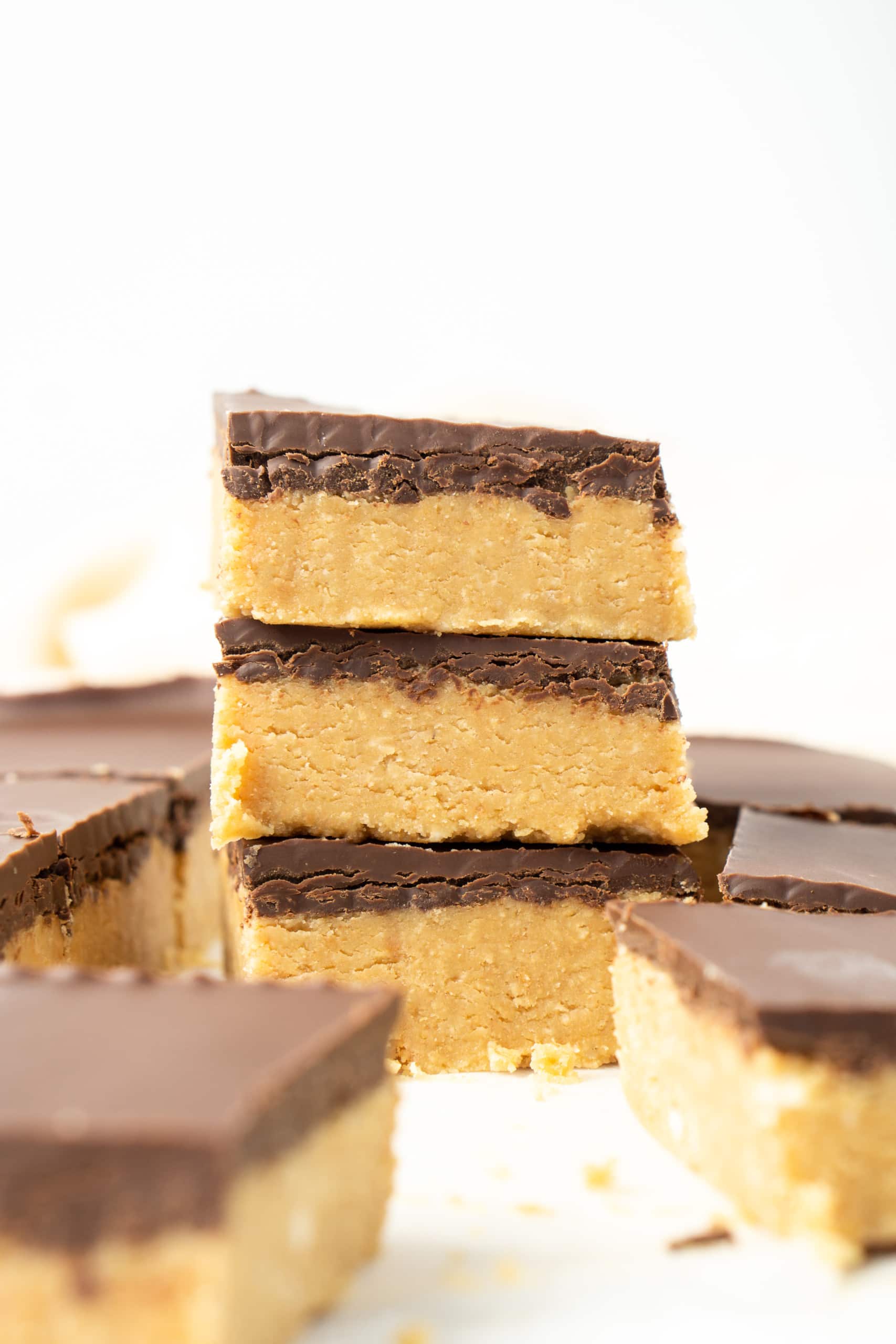Close up of three peanut butter bars stacked on top of each other.