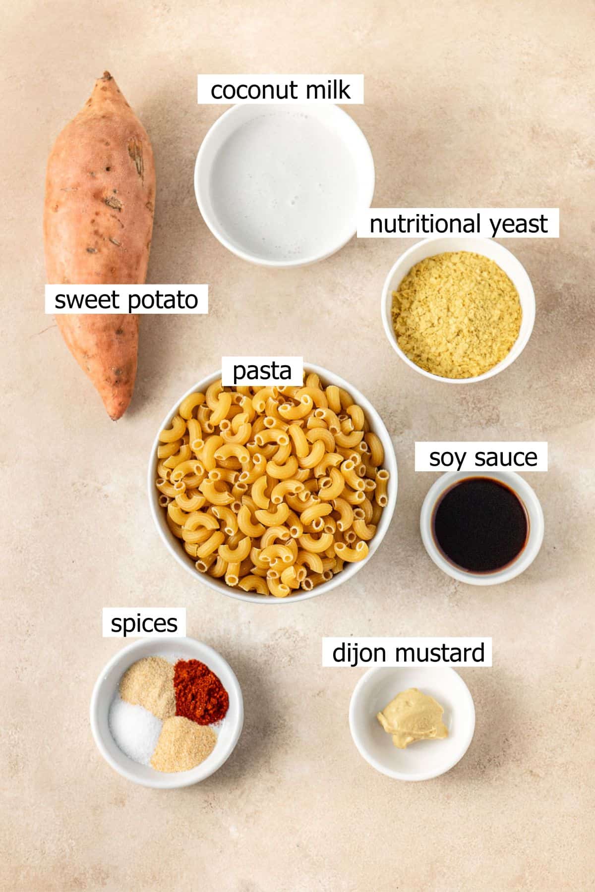 All ingredients needed to make vegan sweet potato mac and cheese laid out in small bowls.
