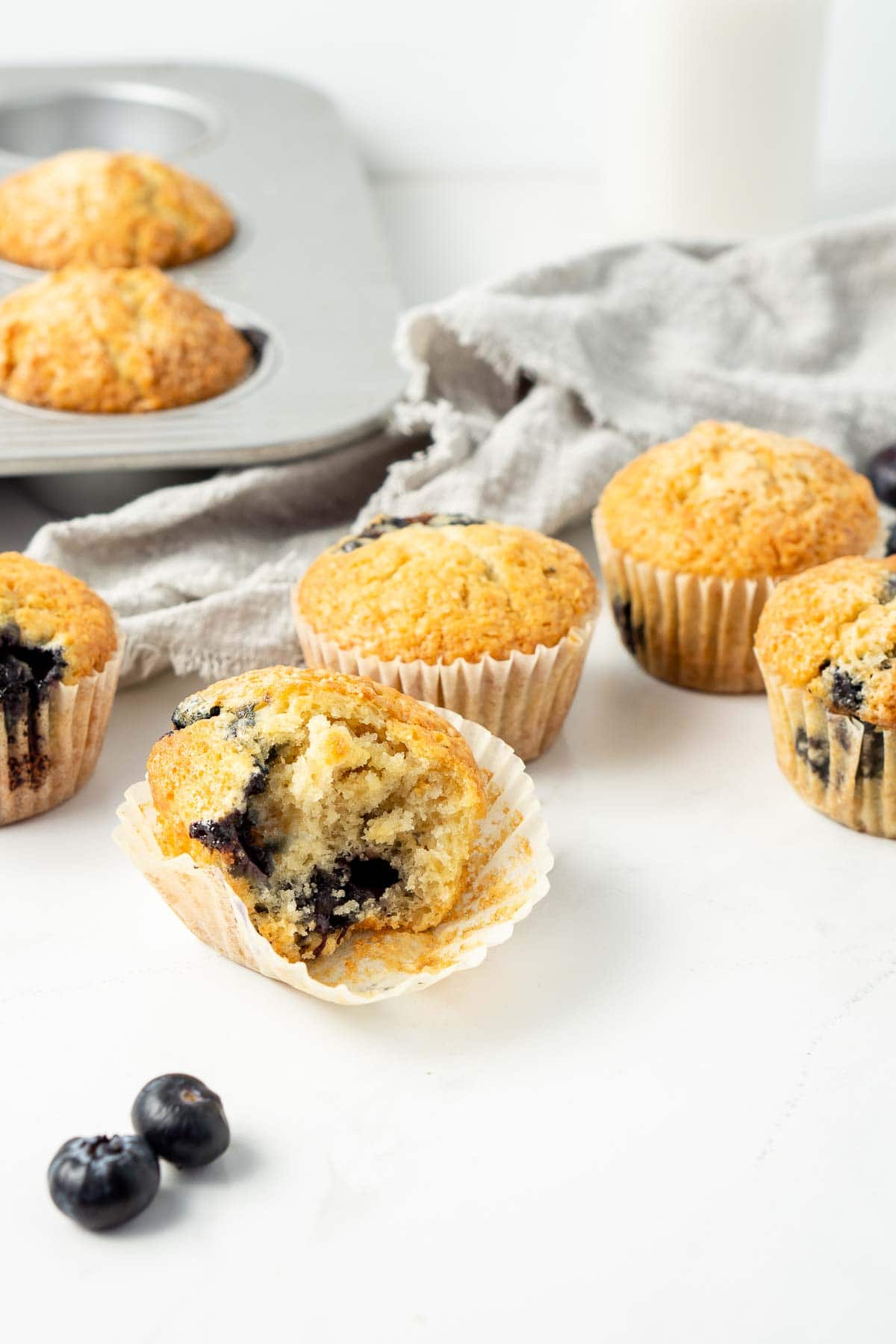 Blueberry muffins with a bite taken.