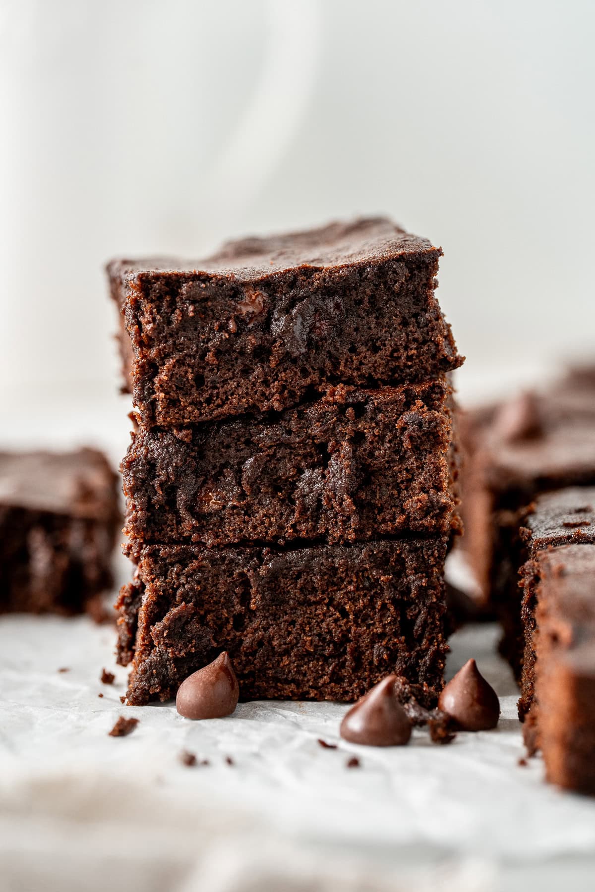 A stack of three chocolate brownies.