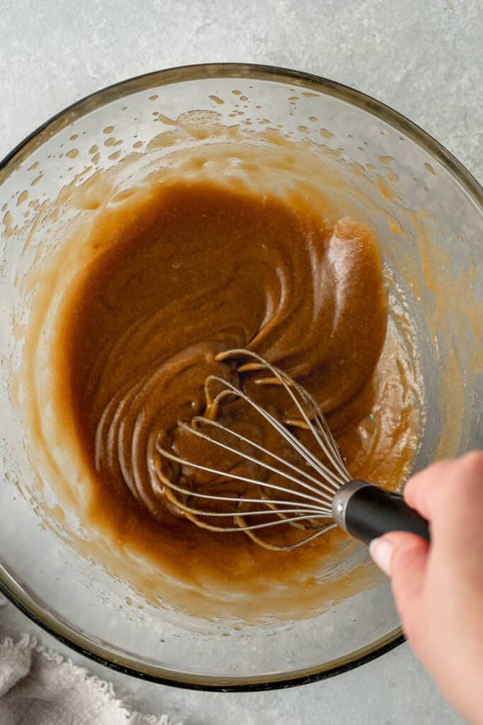 Whisking together the dairy free butter and brown sugar in a bowl.