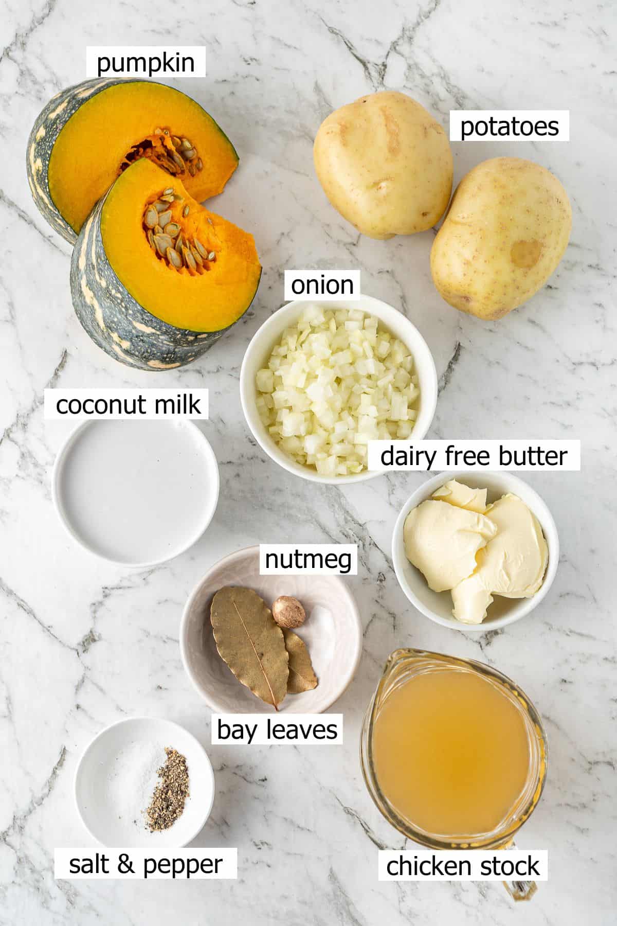 All ingredients needed to make dairy free pumpkin soup laid out in small bowls.
