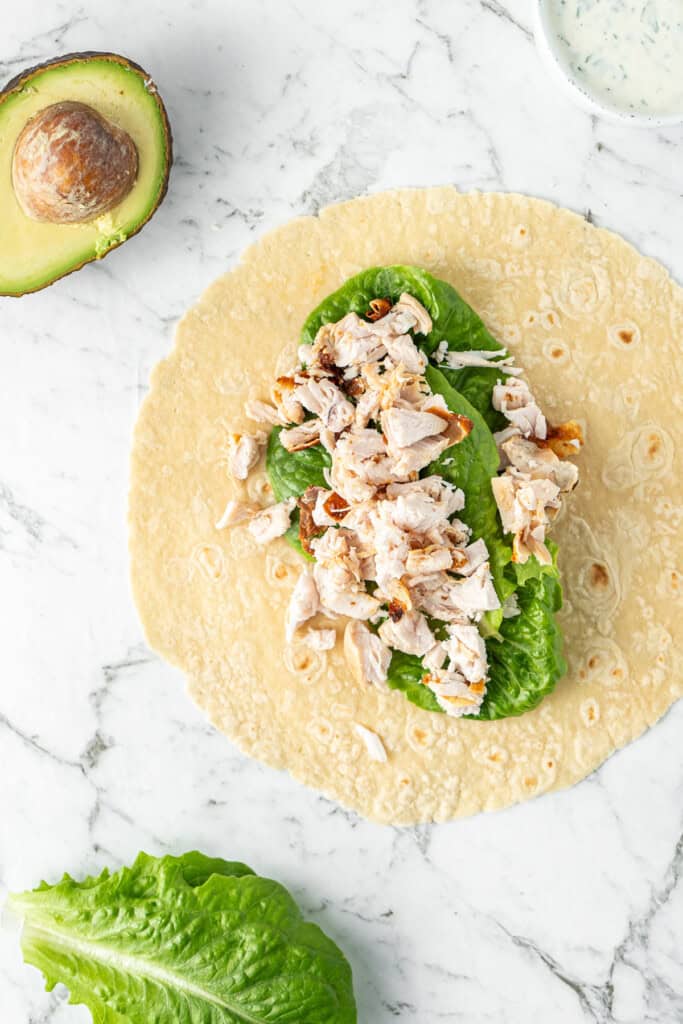 Adding the fillings to the wrap.