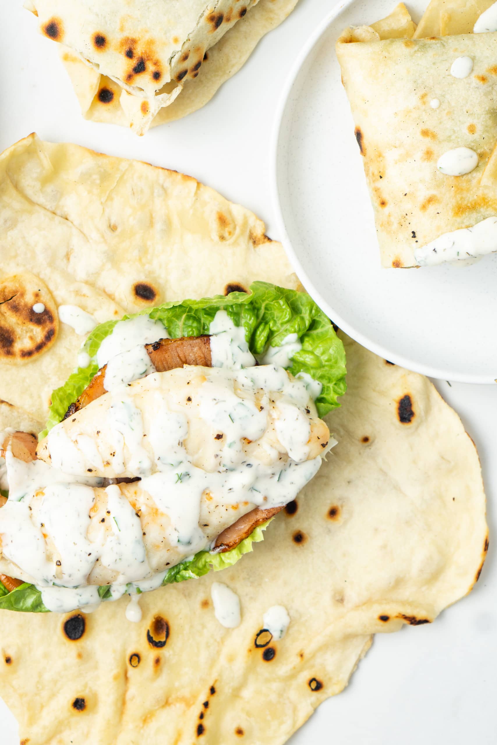 Chicken on a wrap with ranch dressing.