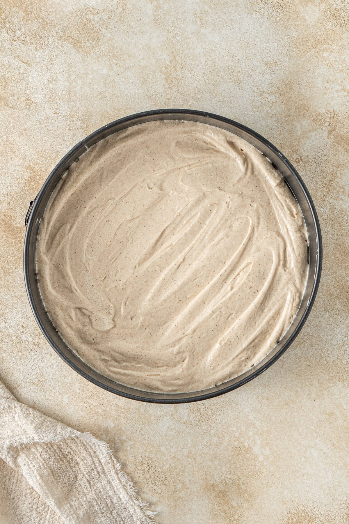The creamy cake batter in a cake tin.