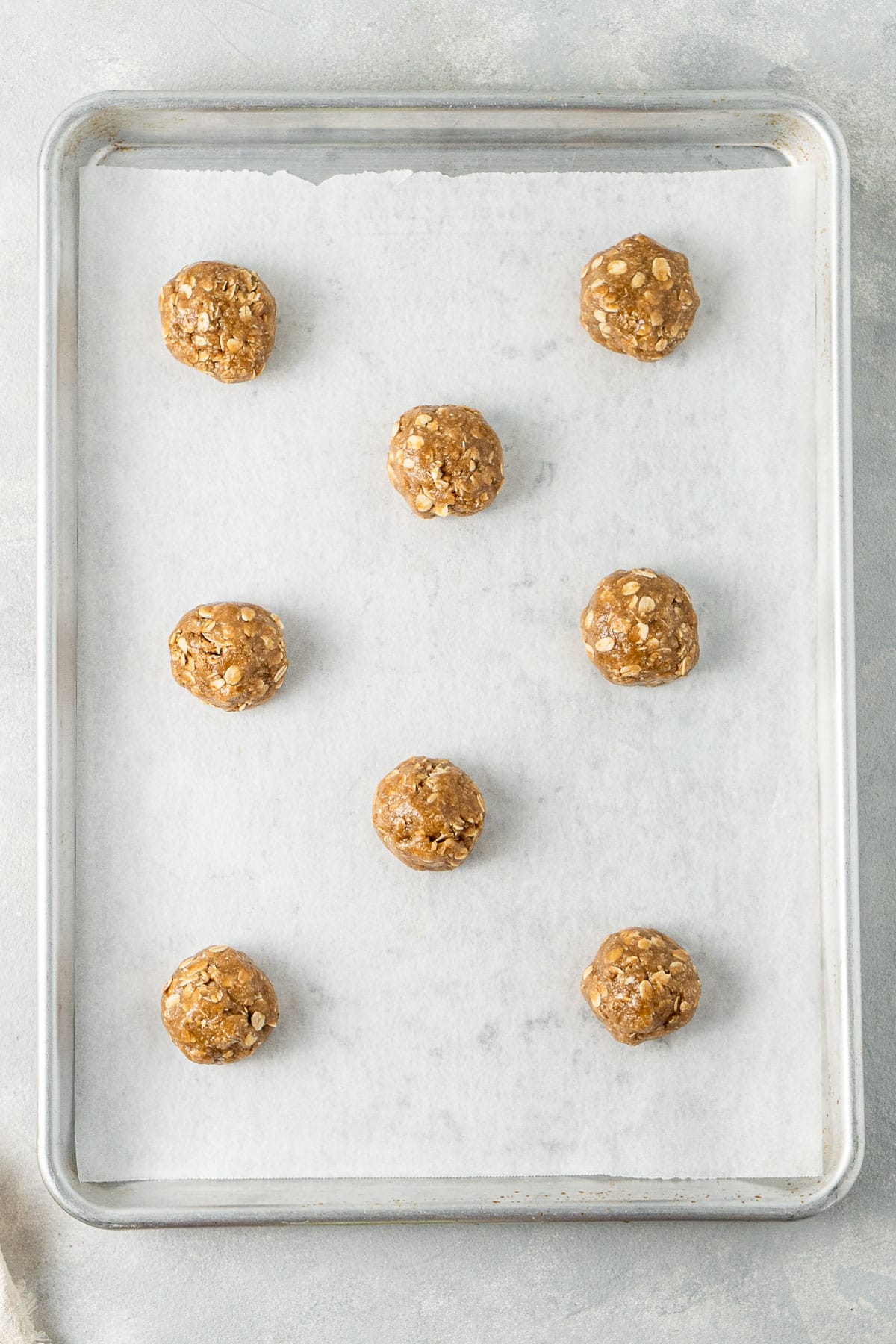 The biscuit dough rolled into balls and placed on a baking tray.
