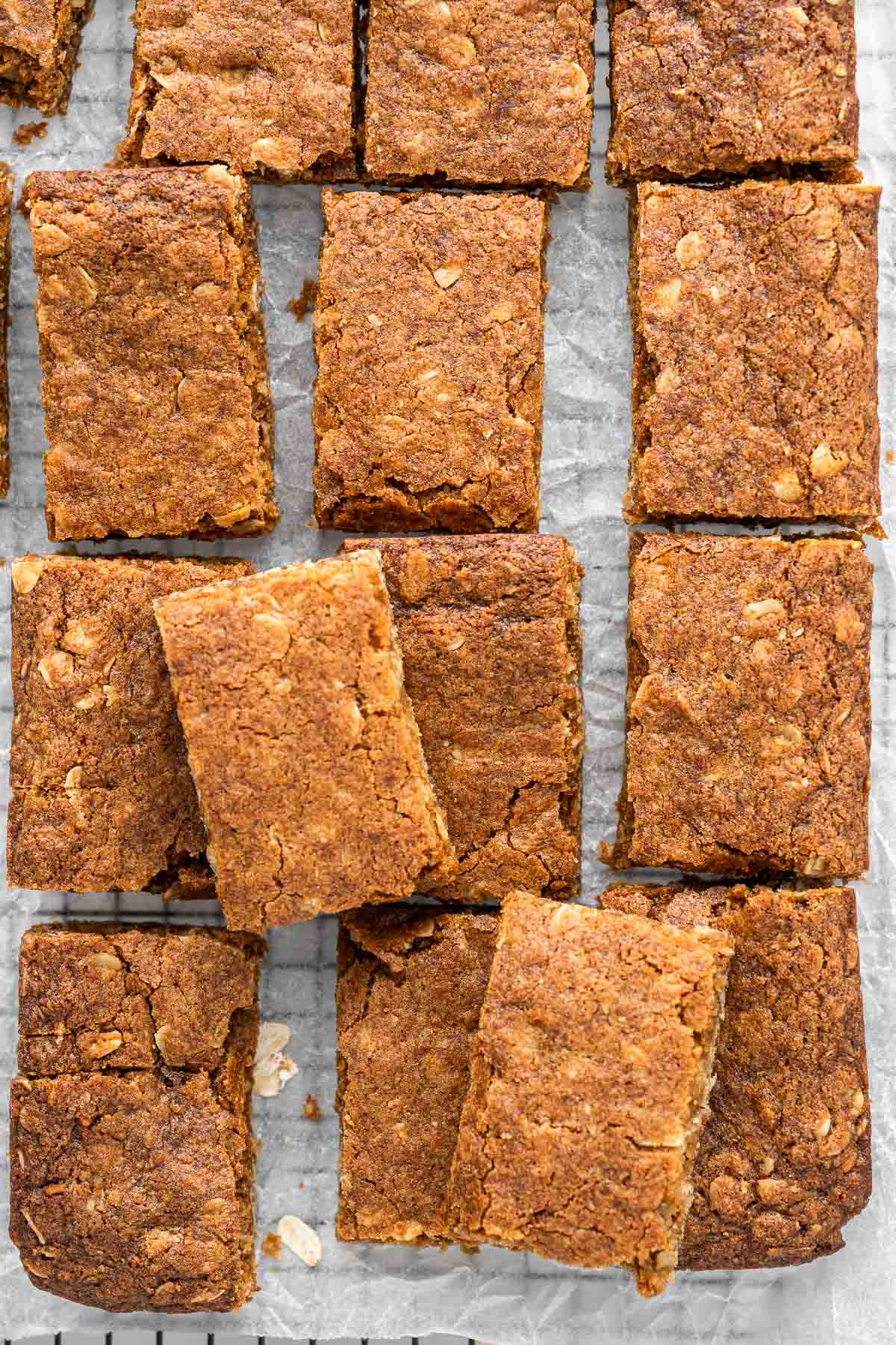 Close up of rectangular pieces of ANZAC slice on a cooling rack.