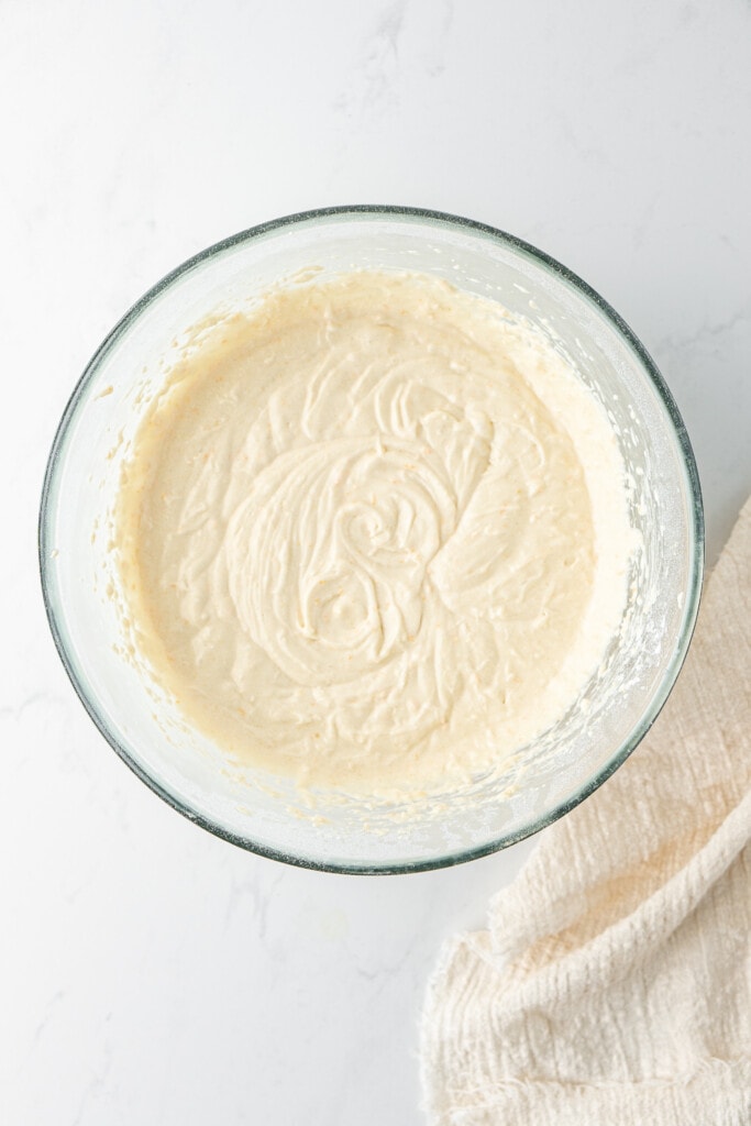 Creamy pound cake batter in a glass bowl.