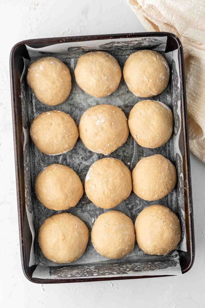 Dough balls in a baking pan ready for the second rise.