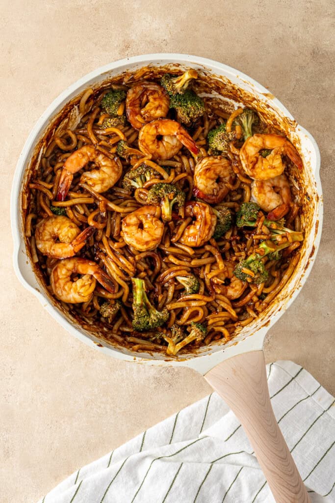 Garlic prawn noodles in a frying pan.