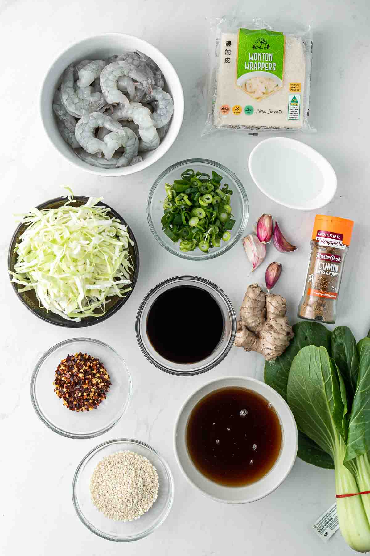 All ingredients needed to make wontons and chilli oil laid out in bowls.