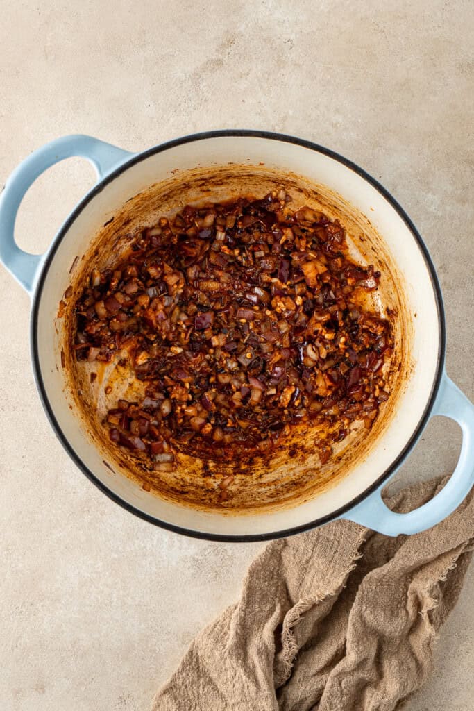 Cooking the onions and spices in the pot.