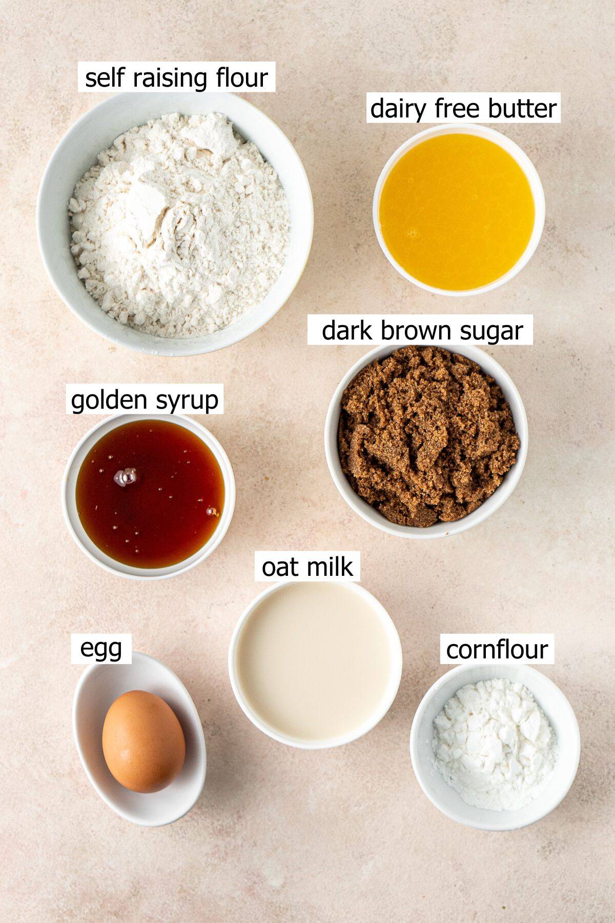 All ingredients needed to make self saucing butterscotch pudding laid out in bowls.