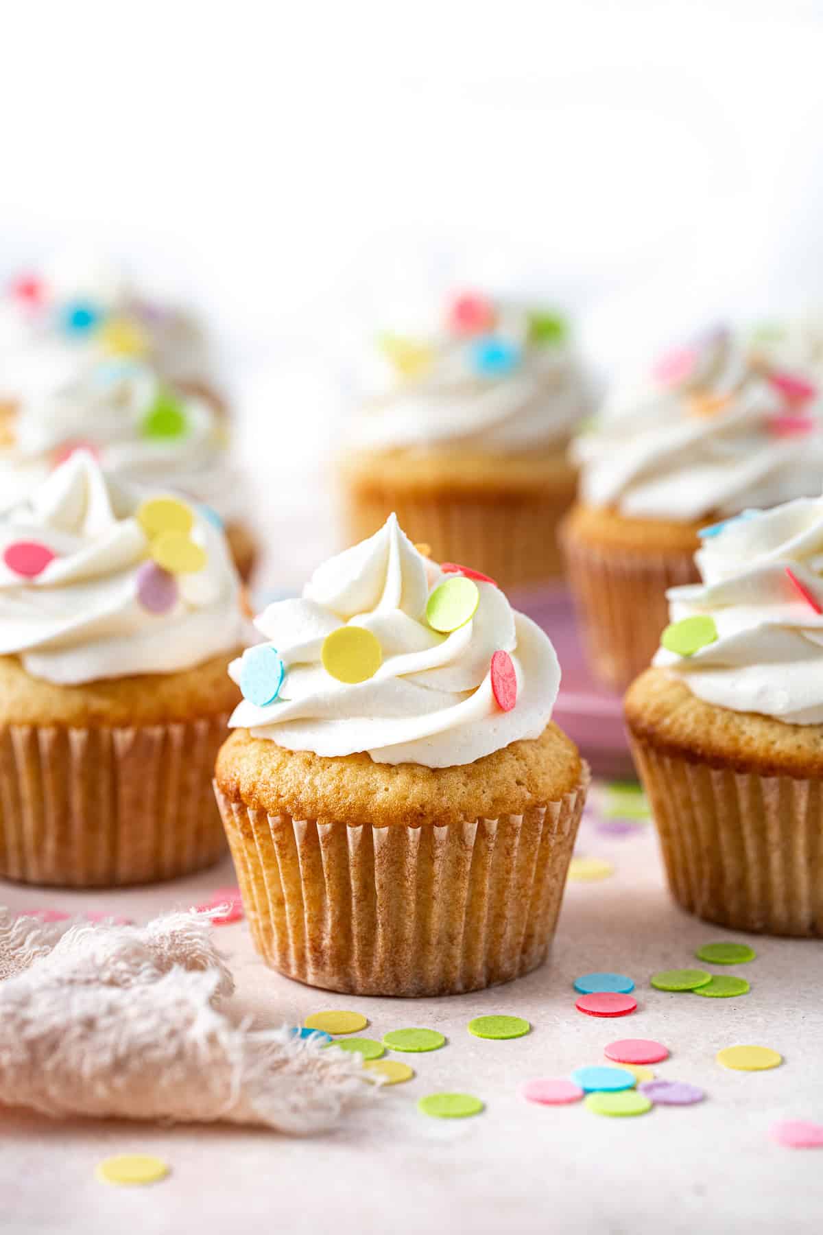 The dairy free vanilla cupcakes with frosting and colourful sprinkles.