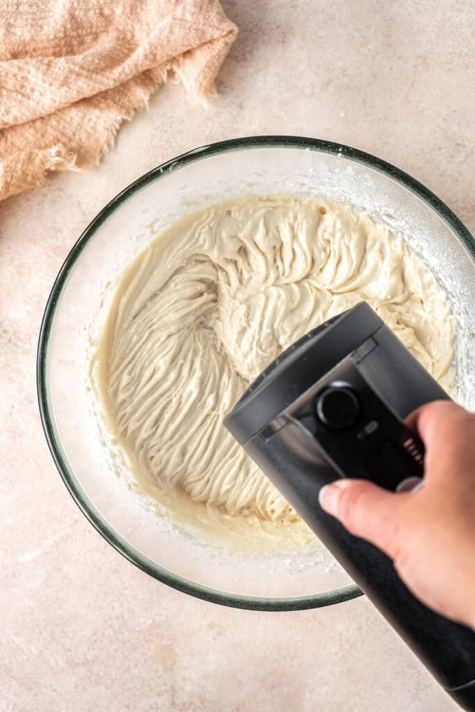 Beating together the cupcake batter in a bowl.