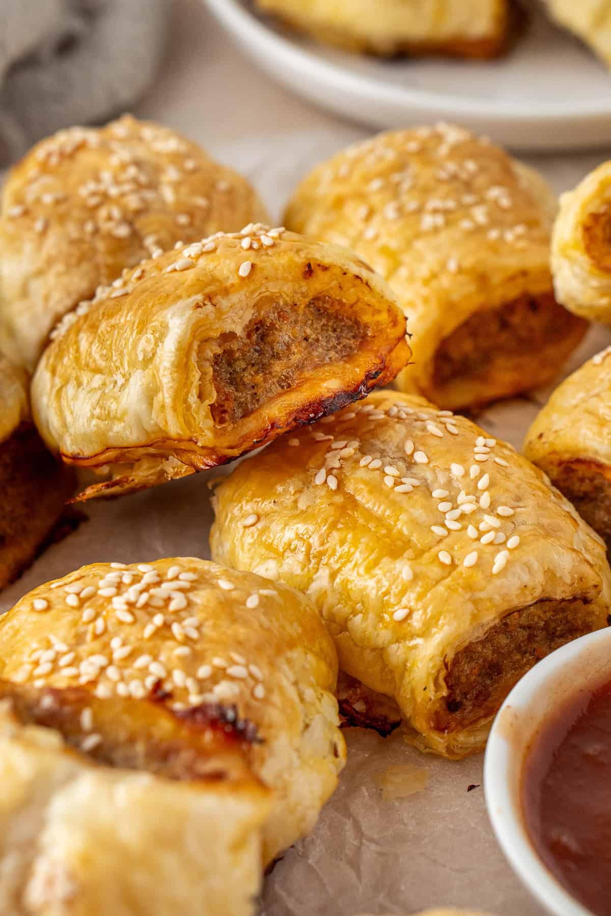 Sausage rolls with tomato sauce.