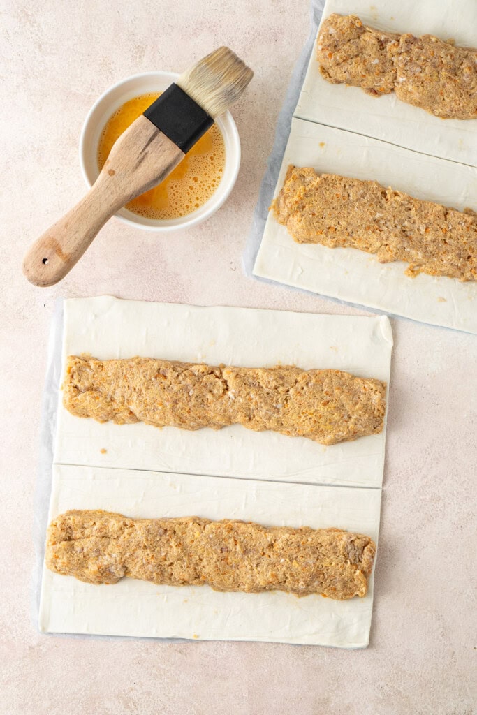Shaping the filling into logs on the pastry.