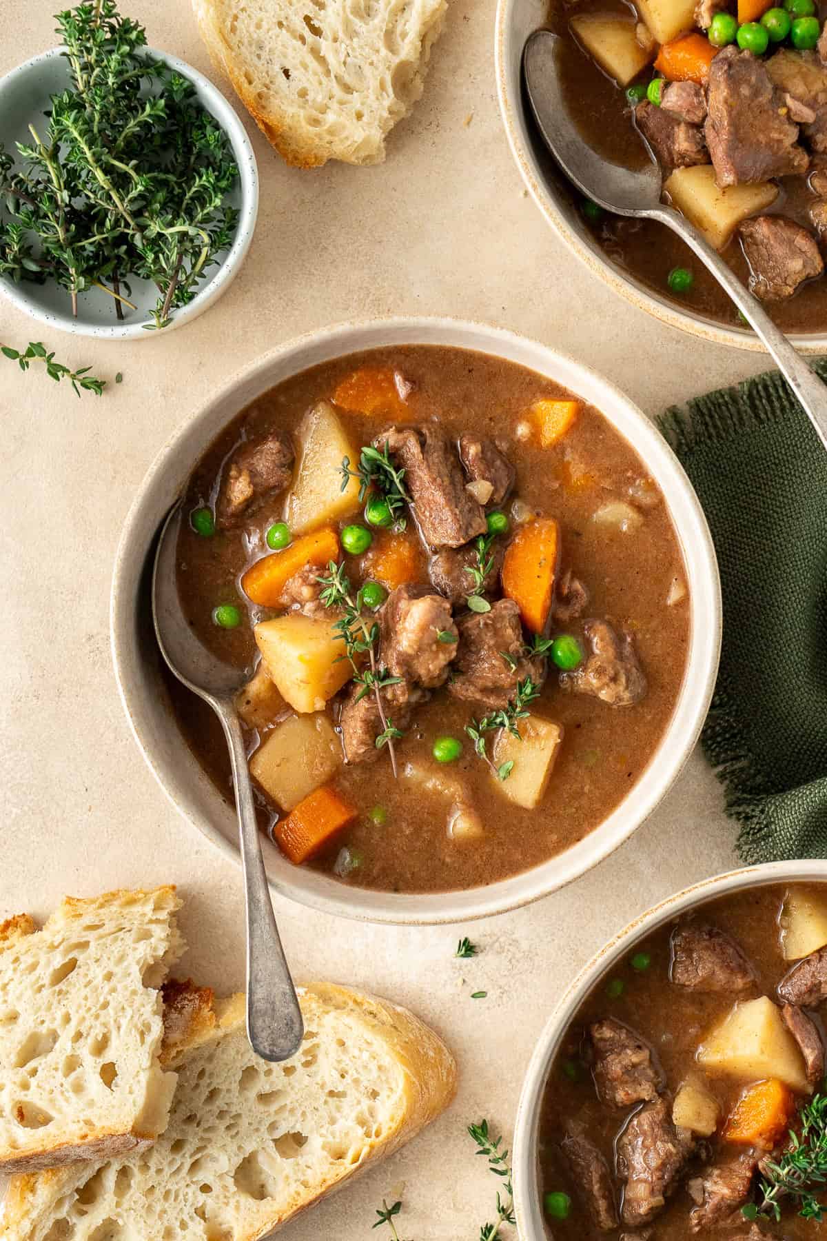 Beef stew in bowls with a spoon.