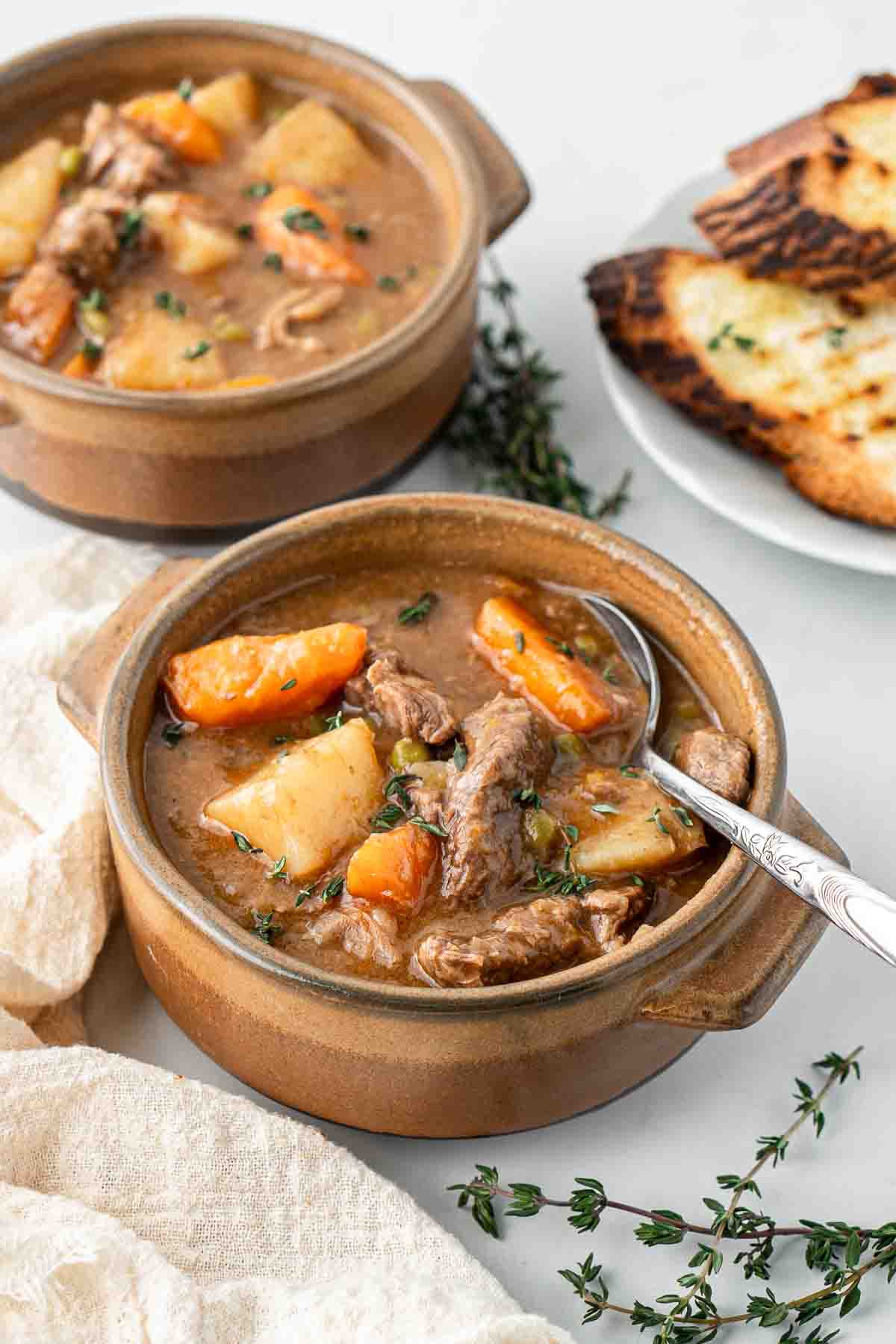 Close up of beef stew with a spoon.