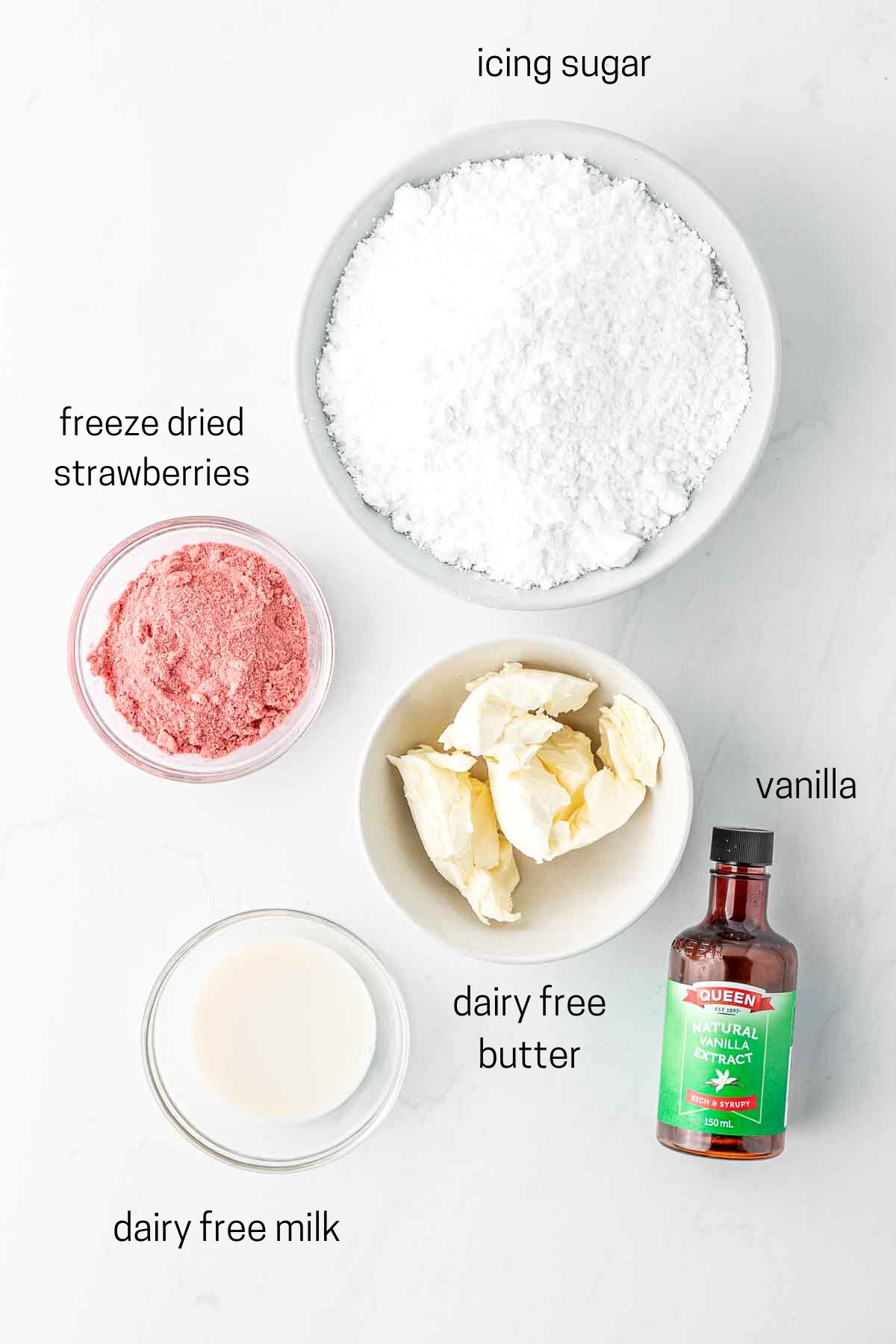 All ingredients needed for vegan strawberry buttercream laid out in small bowls.