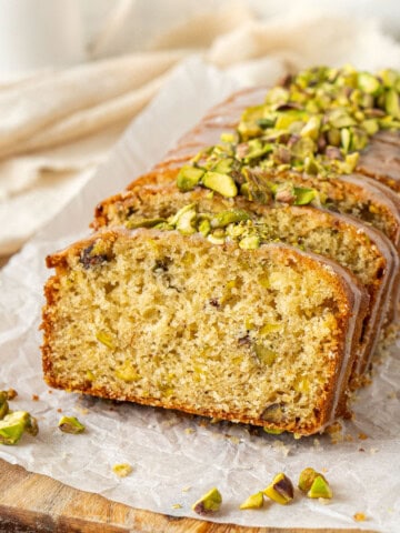 Lemon pistachio cardamon loaf cake sliced.