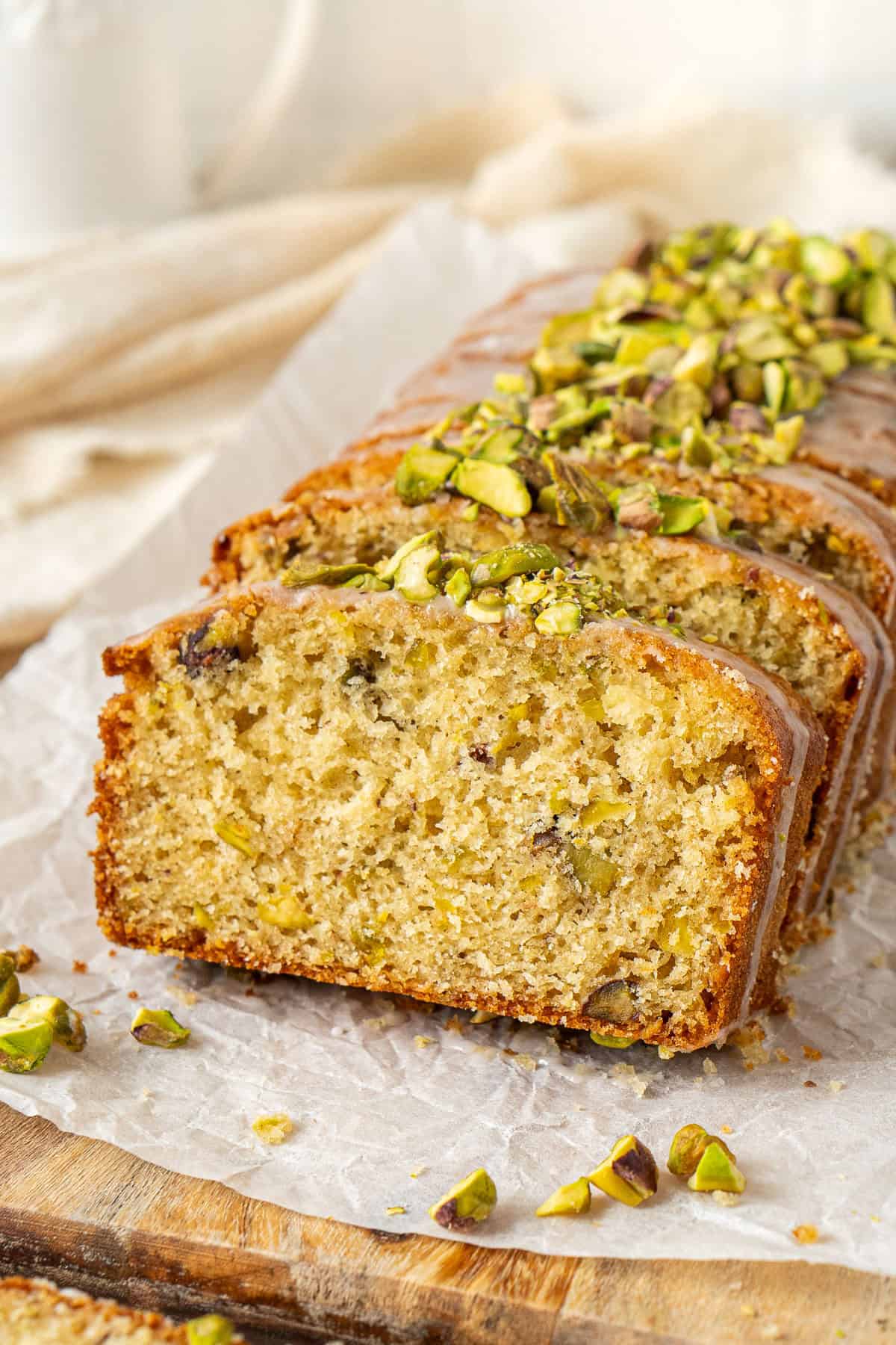 Lemon pistachio cardamon loaf cake sliced.