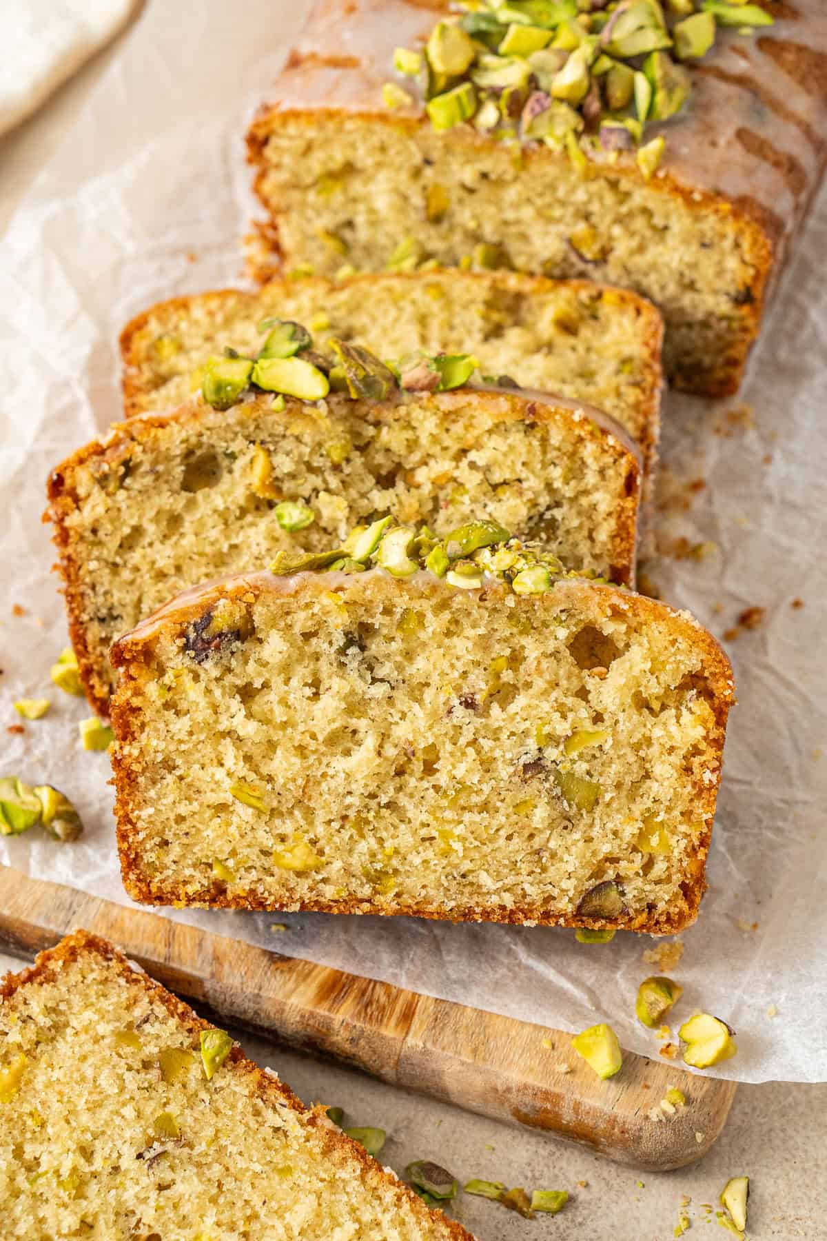 Lemon pistachio cardamon loaf cake sliced.