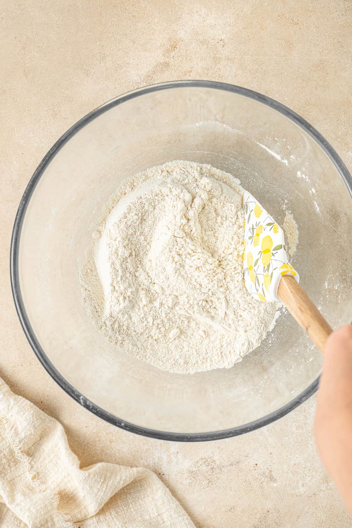 Mixing together the dry ingredients in a glass bowl.