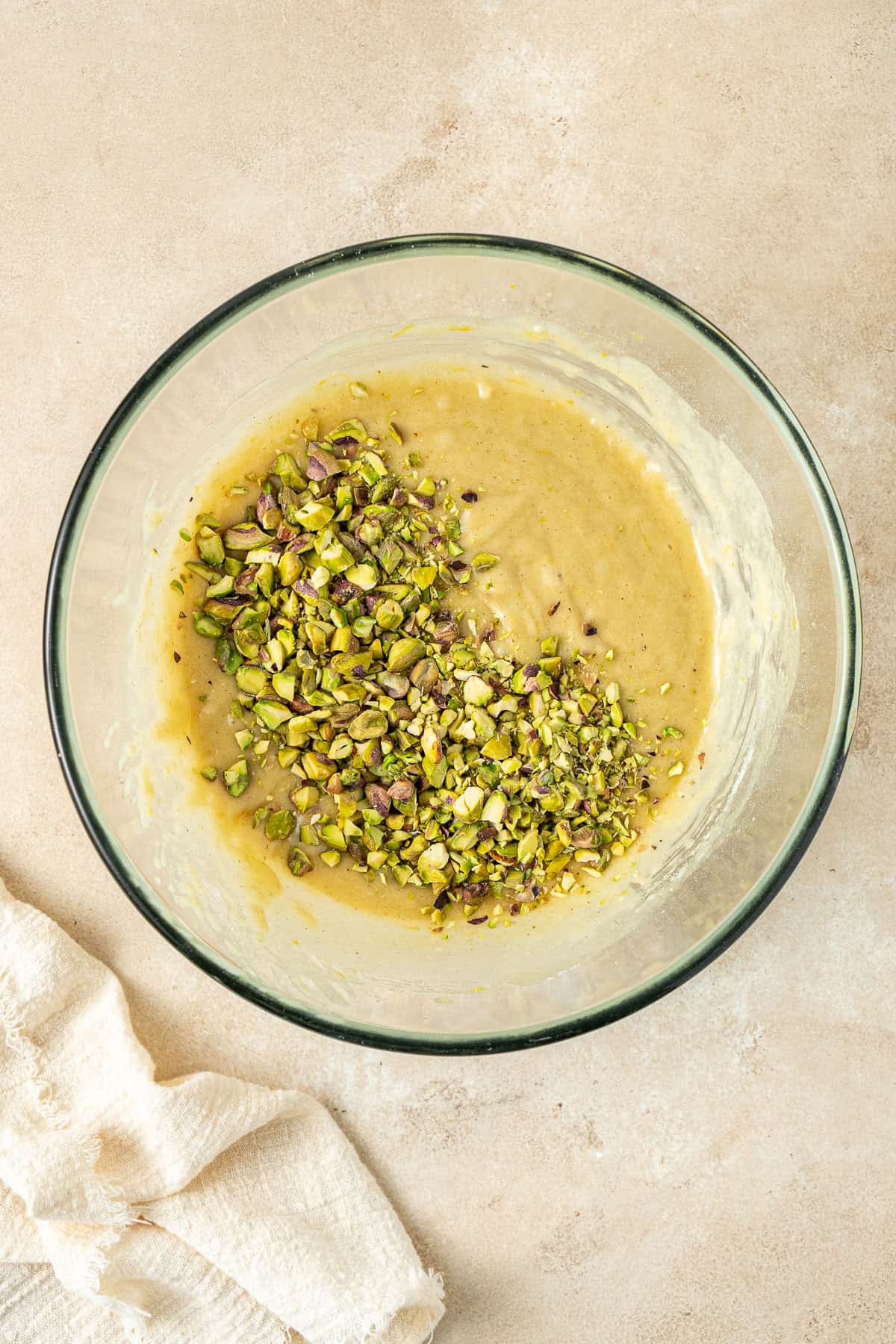 Adding the chopped pistachios to the batter.