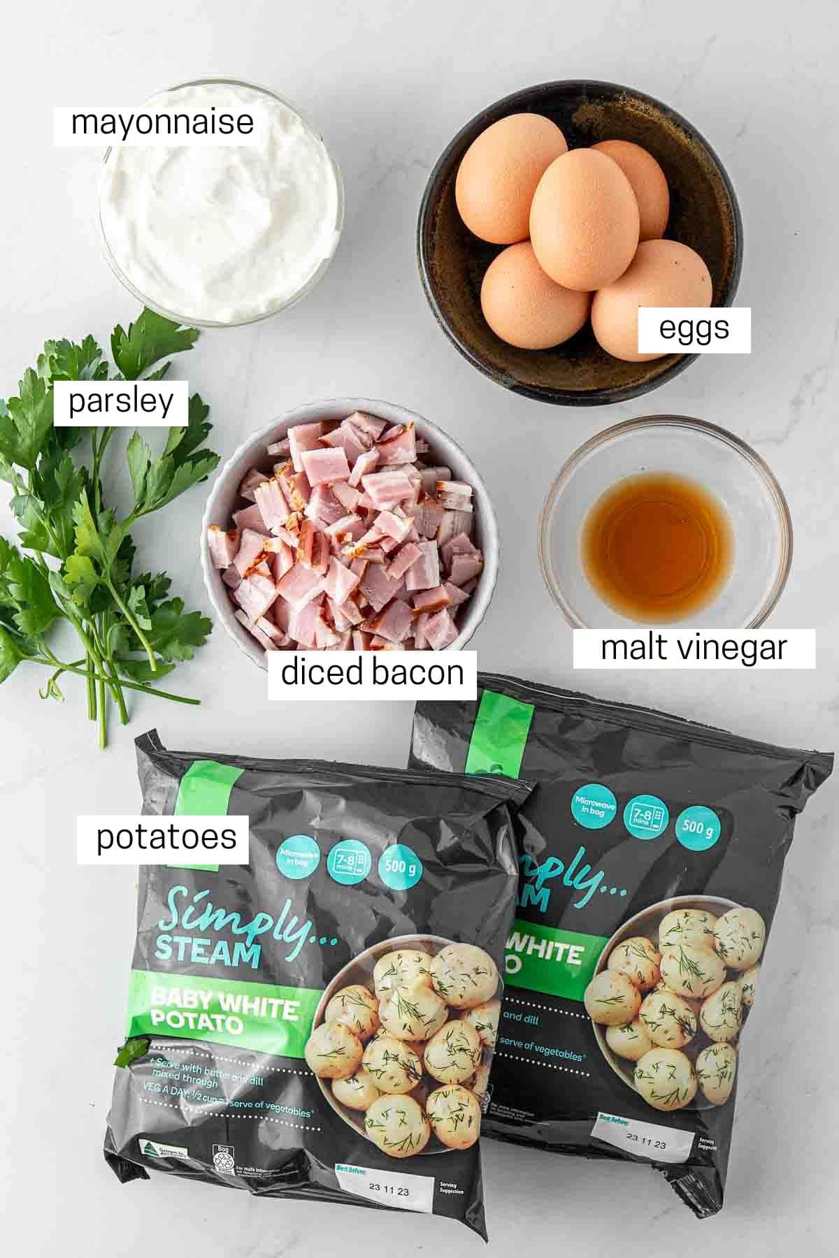 All ingredients needed for dairy free potato salad laid out in bowls.