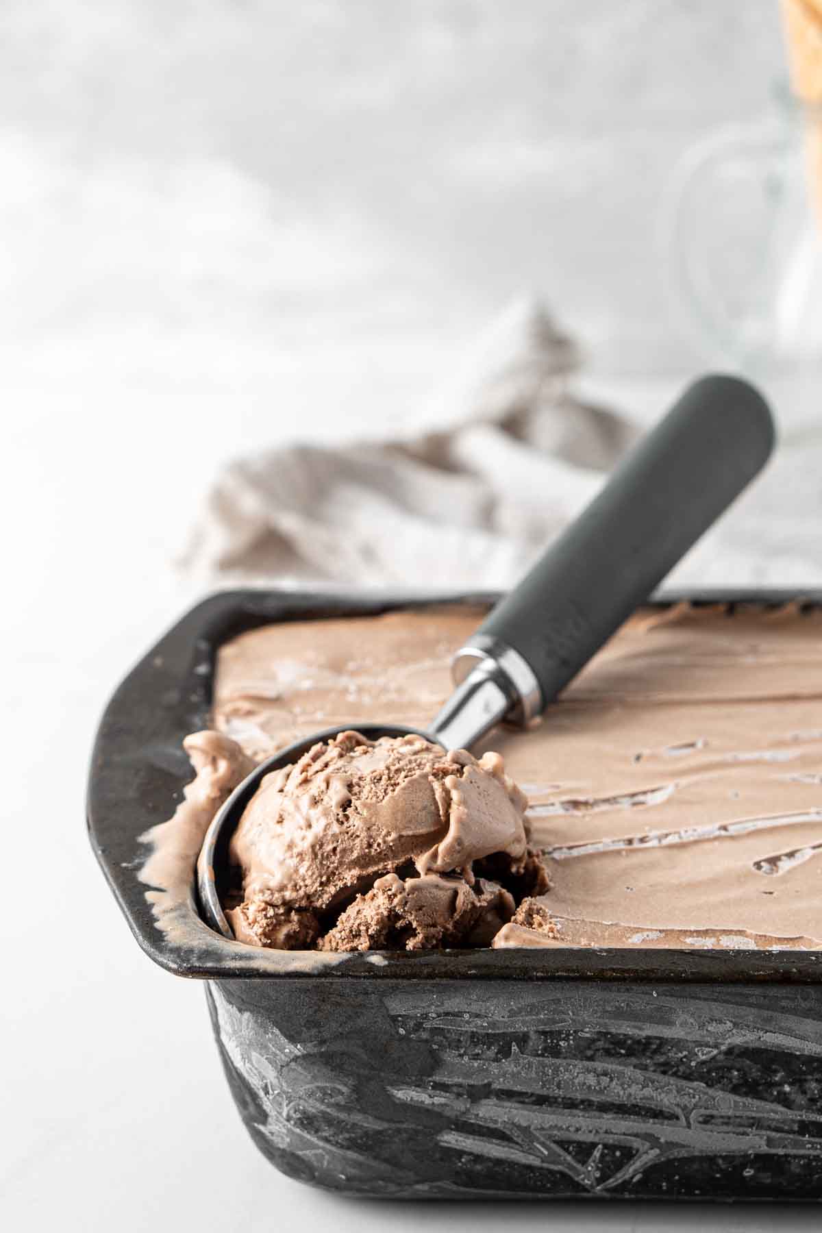 A scoop of chocolate rocky road ice cream.