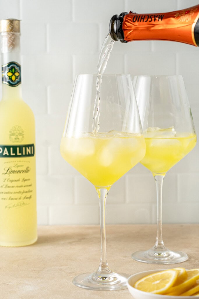 Pouring prosecco into the glass.